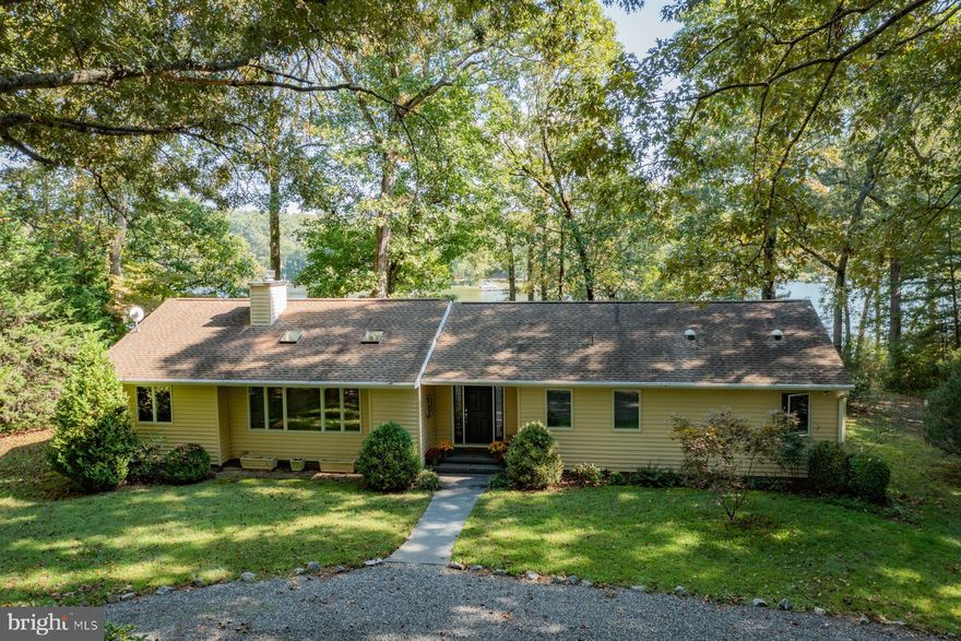 Big views of the Western Branch of the Corrotoman, large pier with boat house, 4’ MLW, boat lift and jet ski lift, perfect elevation with no steps to the water, 3.2 acres for privacy, one level updated home with open floor plan and vaulted ceiilings. This property has it all and comes fully furnished if desired! Completely remodeled in 2008, this home offers an open living/dining/kitchen with waterviews, stone hearth, woodburning fireplace and hardwood floors. The living/dining room opens to a waterside screened porch with ample room for relaxing and dining. The primary waterside bedroom features a vaulted ceiling, walk-in closet and ensuite bath with dual vanities, walk-in tile shower and linen closet. On the opposite side of the home are 2 additional bedrooms and a full bath. There is also a waterside office - or 4th bedroom - served by a third full bath off the separate laundry room. This home has a brand new roof, new septic system in 2020, new generator in 2023 and new lines for All Points Broadband internet. Not in an HOA, not in a flood zone and only 10 miles to Kilmarnock!