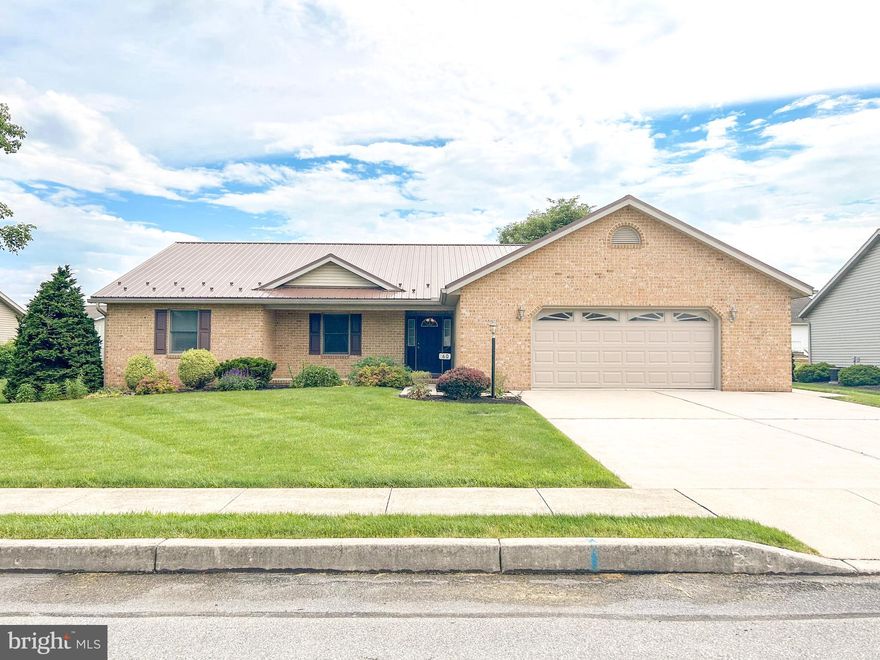 Welcome Home to Parkwood Drive where you'll find one-level living at its finest!  Located in a quiet neighborhood close to conveniences, this home hosts ample living space in all areas.   When you arrive, you'll immediately notice the beautiful concrete driveway, brick front, maintained lawn, and mature landscaping.   Enter from the covered front porch to hardwood flooring leading to a large living room complete with vaulted ceiling and propane fireplace.  The first of three bedrooms is just inside the front door making it perfect for a guest room or office space as it was most recently used.  Back the hallway to the left are a second bedroom, full bathroom, and large primary ensuite with walk-in shower and huge walk-in closet!  On the alternate side of the home, you'll find a spacious eat-in kitchen along with a laundry area paired with half bathroom.  Enter in to the large garage and you'll immediately witness the opportunities for parking in addition to storage.  Two large storage closets are located in the garage along with attic space above for longer-term storage items.

As you travel through the photos,  take notice to the lovely built-ins, ample number of closets, newer metal roof, and covered rear porch!  The lot is just the right size for some small outdoor activities, yet inexpensive to maintain as the most recent owner hired routine lawn care in addition to snow removal.  There is NO HOA in this neighborhood, but it could feel like it in all of the best ways!  The neighbors regularly connect, hold events, and socialize with those who are interested.

Questions?  Want to schedule a showing?  Give me a call today!