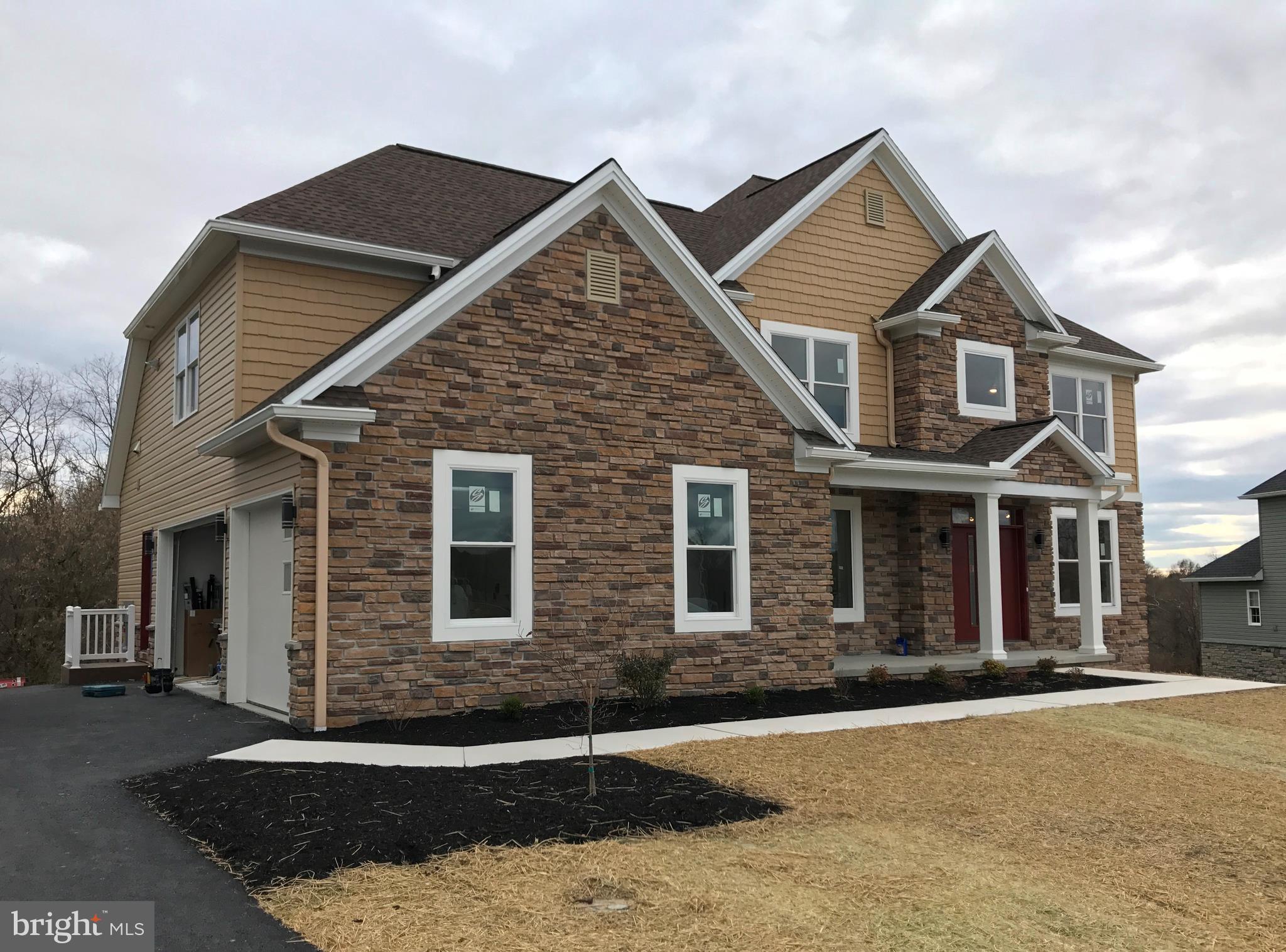Stunning stone & vinyl 2 story with open floor plan, gourmet kitchen w/granite, tile back splash, SS appls., island, 9 ft ceilings, gas fireplace, built-ins, wood floor in foyer, living & dining rm, coffered & tray ceilings, crown & shadow boxing. 1st flr BR w/full bath, 2nd flr laundry, 2 trex decks, central vac, 3 zone gas heat, electric air filter, exposed walkout LL w/9ft ceilings, game rm, add'l BR/den w/bath overlooks green space.