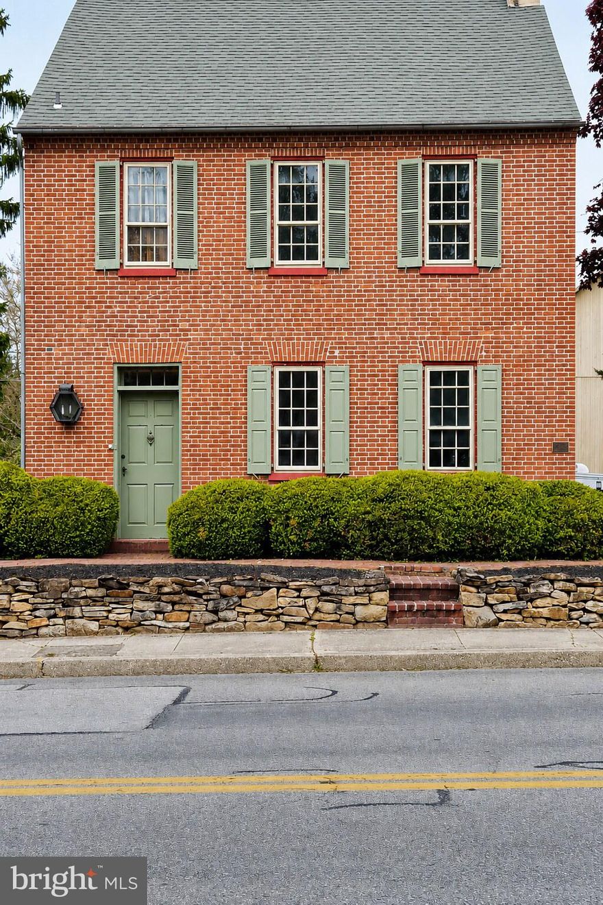 Upcoming Auction June 25th 2026 at 5pm.   
Step back in time with this remarkable 18th-century historic residence, rich in character and architectural charm. Offering approximately 2,445 square feet of living space, this home features 3 spacious bedrooms, 2.5 baths, an eat-in kitchen, family room, formal dining room, and living room.
Original craftsmanship is evident throughout, including hardwood floors, detailed wood moldings, built-in cabinetry, and multiple fireplaces. A welcoming three-season porch with swing provides a relaxing space to enjoy the property’s peaceful setting.
The second floor hosts all bedrooms, accessed by original wooden stairs and banisters. The primary suite includes a full bath with walk-in shower, generous closet space, and convenient laundry area. Additional bedrooms are accessed from the main hallway, along with a cedar closet and attic storage. A third-floor room, historically used as a workman’s quarters, adds further character and versatility.
The home’s grand front entry retains its original hardware and is complemented by a striking corner cabinet just inside. A secondary entrance leads through the three-season room into the kitchen, which also features an impressive original wood door.
Outbuildings & Grounds
A charming brick walkway leads to an exceptional bank barn with a stone and brick foundation, hand-hewn pegged beams, and metal roof. Historically regarded as one of the largest bank barns in Adams County, it once hosted community gatherings and dances.
The lower level of the barn served as the art studio of renowned folk artist Arthur Glazier, known for works such as The Peaceable Kingdom, Victorian Santas, and Noah’s Ark scenes. Today, the barn offers versatile space with parking on both levels and ample off-street parking.
A separate chicken coop—formerly used by Glazier for staging materials—adds additional utility and charm.
The property offers dual access from E. King Street and North Street (rear alley).