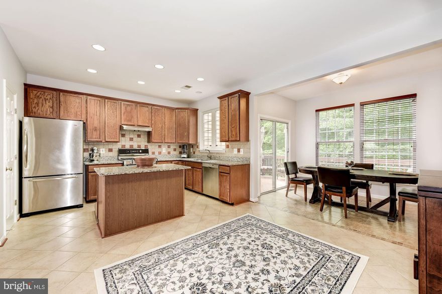 Beautiful & Spacious Townhouse w/ Bump-out on all 3 Levels. Huge Main Level w/ Plenty of Natural Light, Bay Window, & Gleaming Hardwood Floors. Gorgeous Kitchen w/ Granite Counter Tops, SS Appliances, & Durable Ceramic Tile.  Luxury Master Bath Suite w/ 2 Walk-in Closets, His & Her Vanity, Soaking Tub, & Sep Shower. W/O Basement w/ Fireplace & Half Bath. New Paint. 2 Story Foyer! Backs to Trees!