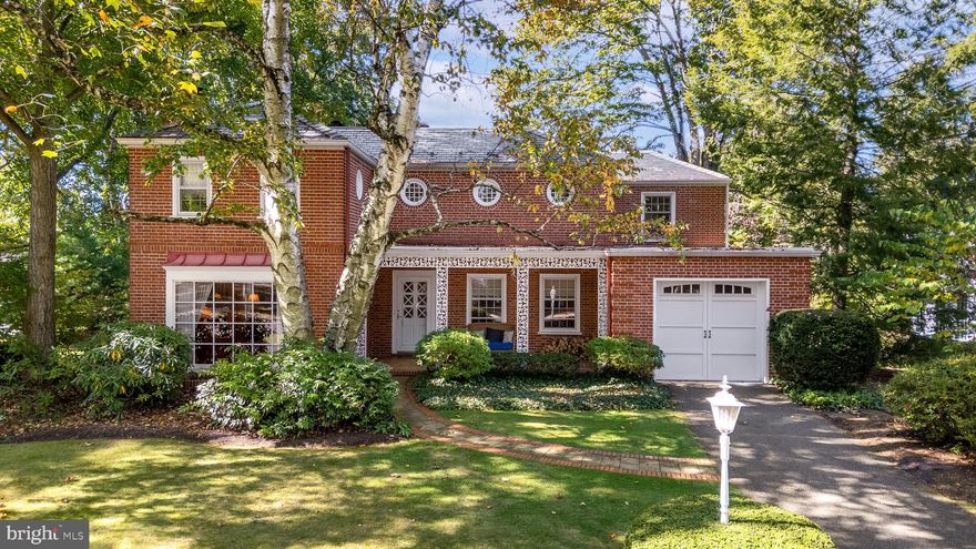 Enchanting and unforgettable! Fall in love with this masterfully designed College Heights Historic residence, crafted by architect Walter Eschenbach in 1939. Perfectly positioned on a corner lot surrounded by majestic trees and lush landscaping, this brick two-story home serves as your private sanctuary. Upon entering you are welcomed by a beautiful crafted kitchen featuring a stunning 14-foot granite island, stainless steel appliances and rich walnut hardwood flooring. The living room, complete with a cozy wood-burning fireplace and a wall of windows, exudes a warm and inviting atmosphere while seamlessly flowing into the formal dining room. Just off the kitchen, the sunroom provides an additional retreat offering access to a serene private patio. A mudroom and half bath complete the main level. The upper level includes a primary en suite with an updated bath and walk-in closet, plus two additional en suite bedrooms. The finished lower level offers a spacious family room with built-in shelving and distinctive window wells, along with a half bath and laundry room. The home also features a one-car attached garage and an additional two-car detached garage, perfect for extra storage, bikes, and more. Situated just blocks from the vibrant campus and downtown venues, this home combines historic charm with modern updates.