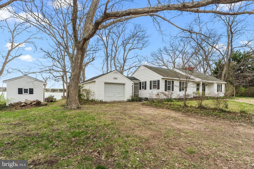 Nomini Watch is a classic river cottage in a fantastic location on Nomini Creek, offering charm, privacy, and exceptional potential. Set on 3.4 acres with approximately 240 feet of waterfront, this 3-bedroom, 2-bath property features a screen porch, woodstove, a garage, and plenty of room to expand or reimagine for the future. The waterfront setting is a standout,  with a private pier with no steps, covered boat slip, covered pavilion, and approximately 4–5 feet mean low water. From the pier, enjoy sweeping views toward the Potomac River and Maryland, adding to the special appeal of this Northern Neck retreat. No HOA. Whether you’re looking for a weekend escape, an investment opportunity, or a property to update and make your own, 375 Hickory Point Drive offers location, character, and endless possibility.
