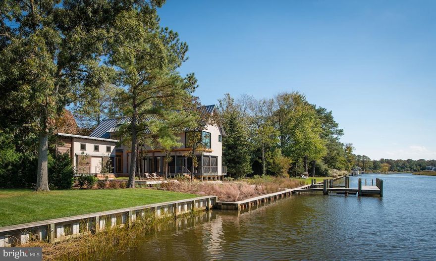 This multi award winning Canal Front house in North Shores was designed to take full advantage of the site and its spectacular perennial views.   Privacy, sustainability and energy efficiency  are foremost in its concept.  An open floor plan with a variety of indoor and outdoor living spaces make this the perfect getaway for all ages.  The house offers bedrooms and baths on both floors, great utility areas, covered parking, lots of secure storage,  and a location that can't be beat.  This home is in move in condition and most furniture is included.  Why go thru the hassle of building when perfection awaits you.  North Shores is a private beach and includes the community pool and tennis courts. The property is Bulkheaded with a Private dock for all your water toys and an extra floating  dock for launching your canoes and kayaks.  Walk out your back door and enjoy Nature at its finest.  Make this your own paradise and enjoy all it has to offer.   Call for an appt now.