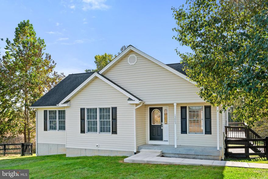 ON THE SUNNY SIDE OF THE STREET! Perfectly situated to all the local amenities. This home features an open floor plan with the kitchen right off the living room, vaulted ceilings, and hardwood flooring! The laundry is off the kitchen in a separate room that also includes cabinetry for storage and a wash sink. There is a deck off the living room/kitchen combination for easy grilling! On the main level you will find the primary bedroom and primary bathroom as well as a secondary bedroom and secondary full bathroom. In the lower level you will find the third bedroom, full bathroom, a den, recreation room with wet bar, cabinetry-perfect for second living space for in-laws or set it up for all the movie nights with friends and family! Welcome home!