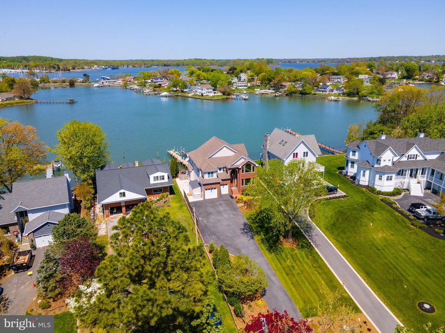 PRICE IMPROVEMENT! Picturesque waterfront. This 6 bedroom, 3 ½ bath home with sweeping views of Ramsey Lake located just off of the South River and Chesapeake Bay has been meticulously maintained with many recent updates. The attention to detail is noted throughout with gorgeous moldings and trim, Brazilian and Canadian hardwood floors, custom built-ins and beautiful plantation shutters. Water views take center stage from nearly every room. Enter the main level through a grand foyer with high ceilings and circular staircase. A formal dining room is located to the right and as you move straight back into the home, you are introduced to the spacious gourmet kitchen with commercial grade appliances, granite countertops and large center island with breakfast bar. The kitchen is open to a circular breakfast room and a two-story great room with custom stone mantle surrounding the fireplace and floor to ceiling windows, designed to maximize natural light and breathtaking water views. Enjoy your favorite beverage on the back porch, located off the breakfast room, while observing all the abundant wildlife West Shoreham Beach has to offer. The open floor plan with multiple gathering areas makes entertaining guests a breeze. The washer and dryer are located on the main floor for convenience. The upper level of the home boasts a master suite, and three additional bedrooms. The luxury owner’s suite offers two walk-in closets, a bay window for enjoying sunsets, a dual sided gas fireplace and a luxurious master bath with dual vanity, frameless glass shower, custom cabinetry, heated towel rack and floors. Easily host your guests with a finished basement offering a sizable wet bar, beverage fridge and sink, theatre room and two private bedrooms (one containing a full bath). The spaces are versatile, so easily convert one of the bedrooms back into a gym, theatre room or play room. This property’s exterior is a perfect place to relax all year round with a spacious waterside deck and patio with Viking grilling. The deck steps down into another inviting outdoor entertaining space with a fire pit. The deep-water pier (MLW 6ft) contains several slips to accommodate multiple boats, a 12,000lb boat lift, a new floating dock to easily launch kayaks and paddle boards, and a jet ski lift. The property is located in the private community of West Shoreham Beach with the popular Mayo Beach Park nearby. This special home is an easy retreat from the heart of Annapolis with close access to Baltimore, BWI Airport and Washington DC. Welcome home to prime waterfront living at its best!