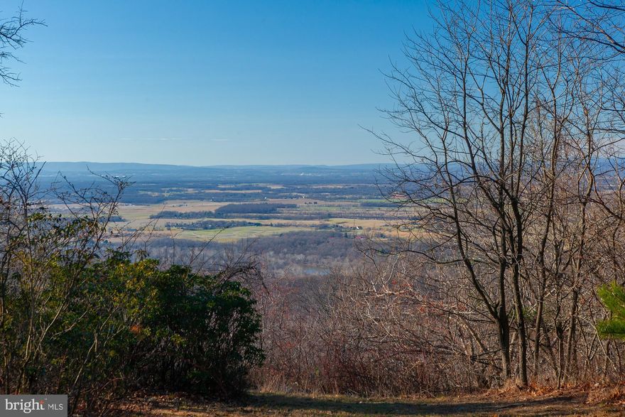 Holiday Special!   Welcome to this dramatic, modern, 3-bedroom, 3-bathroom, 1991 post and beam cedar deck home with wood ceilings throughout, including tongue and groove vaulted and beamed ceilings, gourmet kitchen, large family room, spacious sunroom, 2-story living room with 2-story brick wood burning fireplace, library, main level full bathroom, and main level enclosed garage that could become a very large main level bedroom.  Enjoy walls of glass, elevated views of the Shenandoah Valley plus spectacular sunsets from 10 acres of wooded privacy bordering a wildlife management area.  Every room is above grade.  Comcast cable is available.  This property is a rare find!   Lake Shannondale which has the clubhouse and pool of the Mountain Lake Club, are only a couple of miles away.  Conveniently located near Harpers Ferry, Charles Town, the Shenandoah River, Potomac River, Appalachian Trail, C&O Canal, and lots of outdoor recreation with Shepherdstown, Martinsburg, Frederick, MARC commuter and Amtrak passenger train stations in the area.