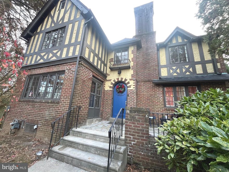 Welcome to this Tudor revival sitting graciously high on a hill in Drexel Hill! This unique property was built by a local architect in 1925 and he used it as his own personal residence. Just at first glance, you can  appreciate the nostalgia of the plastered walls, red oak floors, metal windows and an 8' arched entry door. On the exterior, you can find beautiful English brick and a blue stone front patio with hints of wrought iron railings. Walk into the cozy foyer and notice a slight change in the floor plan, where the dining room and kitchen have been opened allowing for a more fluid path back and forth to the living room. The kitchen was updated about 8 years ago with 42" wall cabinets, stainless steel appliances and a large peninsula to work and prep food. Off the kitchen is an open pantry areas for added storage. From the pantry you can easily access the garage, basement and rear yard. Walk back towards the front of the home and into a spacious living room with natural lighting and a wood burning fireplace. Just off the living room is a bonus sun porch or can be used as great home office! For convenience, there is also a half bath on this level and an other entrance to the rear patio. SECOND FLOOR you have a beautiful hallway area and 4 bedrooms, one in which is the primary with an en-suite bath with double sinks. Each room is nicely sized offering  plenty of daylight and great views of the yard and mature trees. The THIRD FLOOR or 5th bedroom is amazing additional space which can double as a den or play room. Other charming features of the home include: a partially FINISHED BASEMENT with faux fireplace, a NEW ARCHITECTURAL TILED ROOF, NEW CONCRETE work for front steps and railings, a 2-CAR ATTACHED GARAGE, a 3 or 4-CAR DRIVEWAY PARKING, a LARGE YARD, and a BONUS ROOM above the GARAGE.  Come and see what this unique home has to offer!!