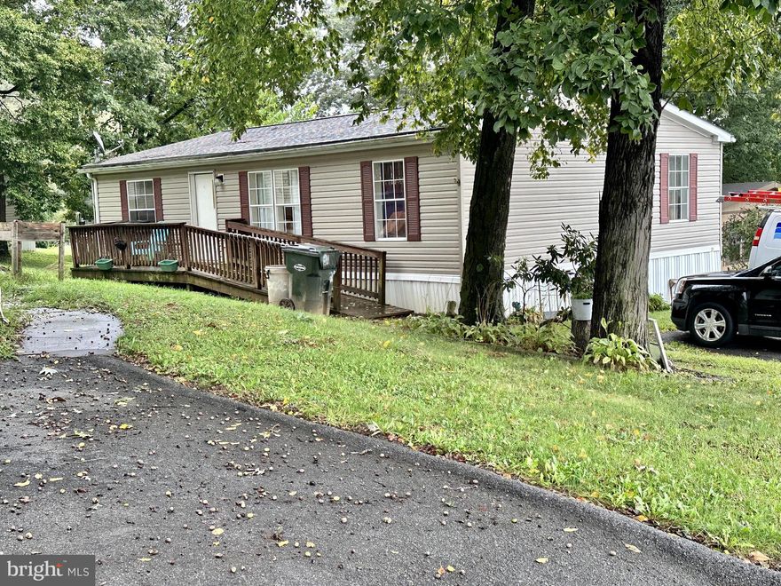 Well-kept 3 bedroom 2 bathroom double wide in the quiet park of Southland Hills Manor.  This charming home features an open, spacious floor plan as well as a ramp for easy access.  The primary bedroom boasts a massive on-suite with a soaker tub and shower. Recent updates include a new hot water heater (Feb 2023) and the roof was replaced (approx 2015/2016).  Outside, you'll love the farmland views and shed for extra storage.  Land rent is $455/month and includes trash.