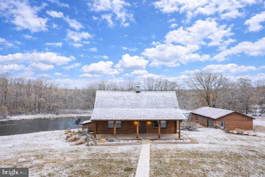 Unlike anything else you’ll find, this exceptional log cabin retreat must be seen and experienced to be fully appreciated! Set on a breathtaking 4.27-acre private lot with a partially wooded backdrop, this property offers a rare combination of rustic charm, thoughtful updates, and a setting complete with its own private stocked pond—perfect for fishing, swimming, or simply enjoying its peaceful, picturesque views. A large full-length front porch welcomes you-there is beautifully restored exterior and interior log work pairing perfectly with rich stone accents and warm architectural details. The main living room features vaulted beamed ceilings and a dramatic stone fireplace, while the charming dining room overlooks the pond, creating a stunning setting for everyday living or entertaining. The spacious eat-in kitchen offers updated appliances, a cozy second fireplace, and an impressive walk-in pantry. A main-level bedroom and full bath add flexibility and convenience. Upstairs, you’ll find two additional bedrooms and a full bath, including a loft-style bedroom overlooking the family room and another bedroom highlighted by a striking stone accent wall with a wood-burning fireplace. The lower level expands the living space even further with a large rec room featuring a wet bar and pool table, plus an additional living area currently used as a primary suite with its own wood stove, full bathroom, and access to the laundry area. Outside, the property continues to impress with a one-car attached garage and an incredible three-car detached garage/workshop complete with its own 240-amp electric service and wood stove—ideal for hobbyists, car enthusiasts, or serious workshop needs. Recent updates include brand-new mini-split heating and cooling systems installed February 2025 with a transferable warranty, a new hot water heater in 2025, a new well pump installed August 2025, a roof replaced in 2018, and fencing installed approximately one year ago, along with the added peace of mind of a whole-house generator. Larger than expected and absolutely unforgettable, this home offers endless possibilities and a lifestyle that is truly one of a kind—an extraordinary opportunity that has to be seen to be believed.