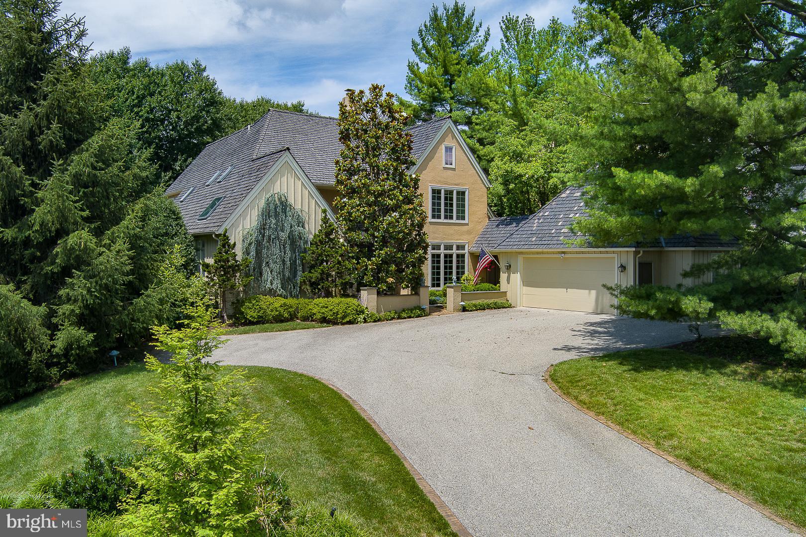 It is no secret that Denbigh remains a very popular and sought after enclave among Buyers today seeking a tranquil, natural setting with 26 acres of permanent open space, gently sloping meadows, a winding stream and beautiful mature trees, with walking paths and no through traffic. A private and almost secluded sanctuary in which to live, among just a few others. Its 19087 location allows for easy and efficient access to almost everything one may want or need - a major convenience today. The Upper Merion Township location provides welcome relief from higher, adjacent property tax assessments. Welcome to 1241 Denbigh Lane, an exceedingly rare Cambridge model, at 3,500+sqft. This is one of very few homes within Denbigh, with a 1st fl owner's bedroom suite, and an attached garage. Advantaged with a premium, highset inner circle lot location for commanding, open and wooded views to the front, backing to open space at the rear for easy access to the grounds and trails, to peace and privacy, just out the back door. The private courtyard driveway allows for an attached, two car + garage, and ample parking. The Cambridge model has become a classic- well lit, with a slightly formal bearing, and great space allocations, but allowing for casual and easy, day-to-day living w excellent flows. Exceptional natural lighting with abundant sunshine, and easy access to the out of doors. The amenities abound. Two story entrance foyer with 18' ceilings has large, south facing transom window for abundant natural light, with impressive scale. Foyer has hardwood floors, coat closet and powder room with underlighted vessel sink. Double front entrance doors, hardwood floors. Foyer flows graciously straight through to the full size, formal living room, with no step down! Living room has fireplace, 18' high ceilings for good scale and great window wall, with atrium door, straight out to the private deck. From the foyer to the right is the sunny dining room, and to the left is the owners main floor bedroom suite. Through the dining room lies white on black island granite kitchen with tile backsplash, breakfast area and bay window overlooking a rock garden. Island has cooktop and vent, with double wall ovens, a dry bar w clear ice maker and a beautiful hutch desk area. Kitchen opens dramatically to the two story family room with vaulted, 18' ceilings and a stone fireplace hearth. Family room opens with oversize sliding door w transom window to the large, rear custom deck. Kitchen has rear laundry/mud room and pantry. The owner's full bedroom suite has pretty windows, double doors, a luxe, white marble bathroom with dual walk-in closets, twin bowl vanity and full soaking tub, private WC and glass stall shower with rain head and steam unit, all en suite. Bedroom suite opens at the rear to the cozy, private library/den with beautiful built-ins, with a sliding glass door to the patio. Foyer has transverse stairs to the second floor, with open balcony landing and two, large en-suite bedrooms, each with sunny windows and very large closets along with full, private bathrooms. Separate, oversize walk-in storage closet. The first floor laundry room opens to the garage breezeway for access to a heated, two car attached garage. The full, unfinished lower level has excellent storage capacity and potential to further finish, with a wine storage closet Spaces in use currently include a workshop, a fitness area and a studio. The very well run HOA attends to all of the landscaping, plowing and maintenance work necessary to keep both the house and community in top notch shape. If easy and elegant living in a parklike environs appeals to you, please come and see this great opportunity at 1241 Denbigh Lane.