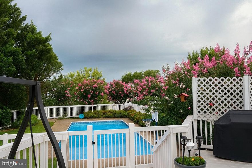 Get ready for vacation style living with a beautiful pool, deck and spacious home!  This inviting three‑level home in the sought‑after Leeland Station subdivision offers plenty of space with the opportunity for expansion in the walkout basement.   Just minutes from the Leeland train station.

The main level offers a spacious, open layout that includes the kitchen with its adjoining eat‑in/breakfast area, the family room with a cozy gas fireplace, a formal living room, a formal dining room, and a convenient half bath.  This spacious layout offers flexibility for work, play, and entertaining.

The kitchen is thoughtfully designed with pull‑out cabinetry for easy storage, a center island perfect for prep and gathering, and abundant counter space. The adjoining eat‑in area opens directly to the deck, creating a seamless flow for entertaining. From here, the kitchen connects to the family room with a cozy gas fireplace, making it the true heart of the home.

Step outside to your own backyard oasis. A sparkling pool serves as the centerpiece, surrounded by a privacy fence and lush landscaping that create a secluded, serene retreat. The deck offers plenty of space for summer barbecues or quiet evenings outdoors, while the front porch adds charm and welcoming curb appeal.

Upstairs, the owner’s suite is a true retreat. With vaulted ceilings, generous proportions, and abundant natural light, it feels like a private sanctuary. The en suite bath features a soaking jacuzzi  tub, separate shower, and dual vanities, designed with pull outs in cabinets,  great for everyday convenience. Three additional spacious  bedrooms and a second full bath complete the upper level, offering space for family, guests, or hobbies.

The home also features an upgraded garage that goes well beyond standard construction. It’s built 4 feet longer than a typical garage, offering extra room for larger vehicles, a workshop area, or additional storage. The entire space is fully insulated from top to bottom, including an insulated garage door, creating a more comfortable environment year‑round and adding meaningful energy efficiency.
Additional highlights include  an unfinished basement ready for customization—whether you envision a gym, recreation room, or more.