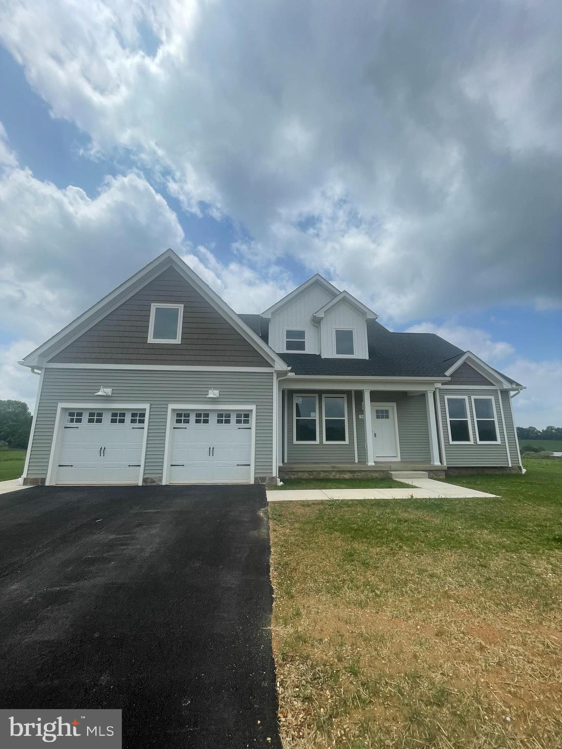 This brand new move in ready home has luxurious features like a large 15' x 20' great room with fireplace and vaulted ceiling for a great entertaining area or cozy family gatherings, a chef's delight kitchen with gorgeous upgraded 42" cabinets, stainless steel appliances, an oversized island with stunning quartz countertops. This kitchen is features extra extensions to the floorplan, extending the already beautiful space. Retreat to a luxurious owner's bath you deserve with a dual vanity, tiled shower to ceiling, frameless shower door, and a beautiful vessel soaking tub. The owner's bedroom includes dual walk in closets, cathedral ceiling and fan, and lots of natural light! Upstairs the additional bedrooms are oversized and include walk in closets. Additional features such as 9' ceiling and tall windows on the first level, brushed nickel knobs throughout, detailed interior doors, and an upgraded trim package set this home above the rest. The unfinished basement walks up onto a beautiful backyard, and includes a rough- in plumbing allowing for the large space to be utilized for your every need in the future and expand your ample living space even further! This home is being built in a beautiful community with a great location for an easy commute to MD or surrounding areas.