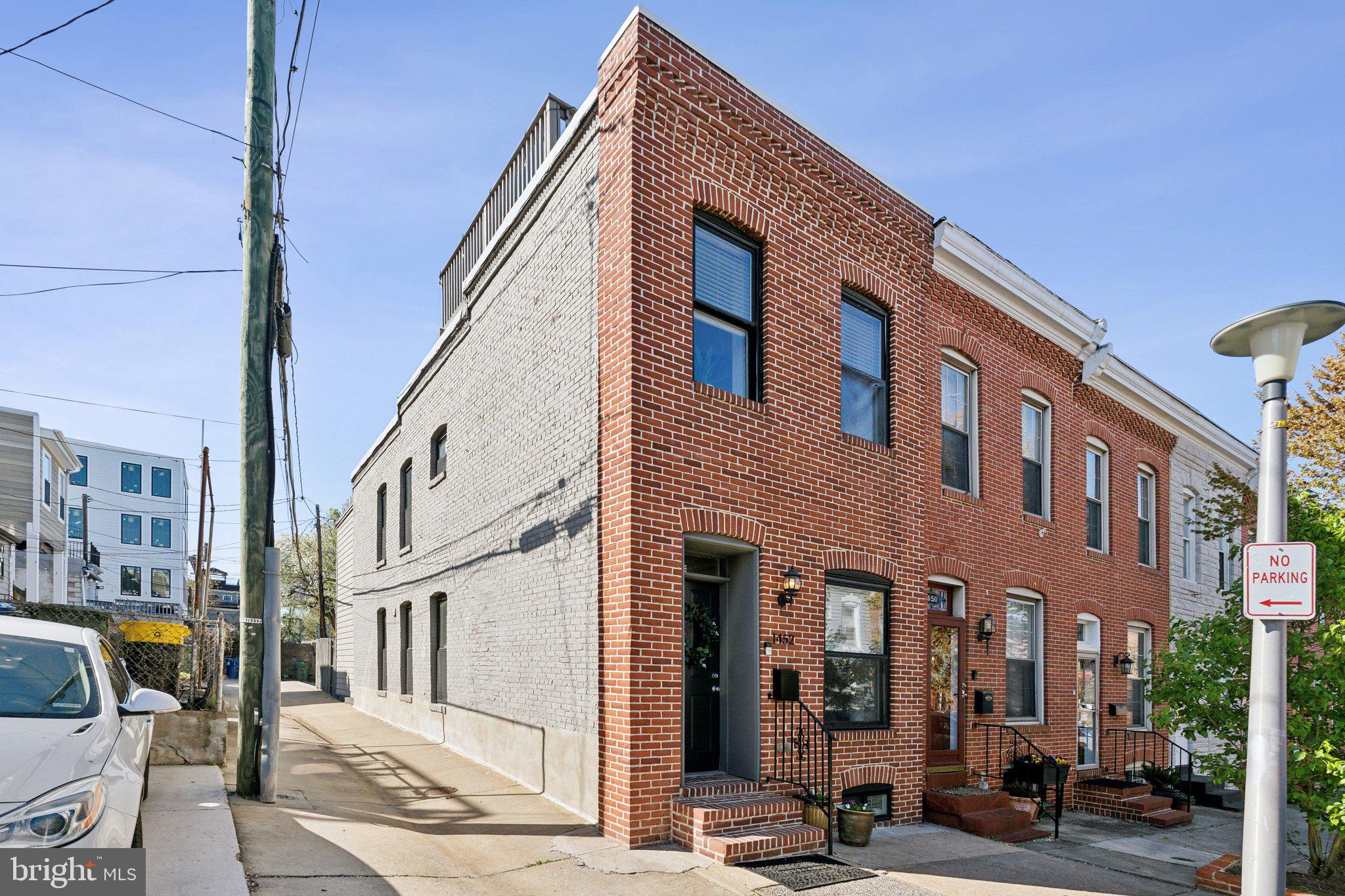 Welcome home to this lovely end-of-group rowhome on an extremely sought-after block in Riverside with a 2 CAR PARKING PAD! The bright, open floor plan includes a spacious kitchen and dining area featuring stainless appliances, granite counters w/breakfast bar, dark wood cabinets, brushed nickel hardware, pendant lighting, and access to the fenced yard and parking pad. The living room has a coffered ceiling, exposed brick and a transom over the front door. Upstairs you will find 2 bedrooms and 2 full bathrooms. The Owner's Suite is sure to impress, with its dramatic tray ceiling, walk-in closet with custom organizers, and modern full bathroom with granite vanity, separate ceramic shower including multiple shower heads and seat. The fully finished lower level features a 3rd bedroom, full bathroom, laundry closet with washer & dryer, and large utility closet. Additional features include hardwood floors, additional exposed brick accent walls, crown moldings, recessed lighting, ceiling fans, and so much more. Relax on the rooftop deck and enjoy gorgeous views of the Inner Harbor and Baltimore City. The home was totally rehabbed in 2012. Recent upgrades include- new roof in 2020, new water heater 2024, new washer 2021, new ejector pump 2021. This is a GREAT location in Riverside, nearby Locust Point, Federal Hill and the Inner Harbor which offers a wide variety of local businesses and plenty of shops and restaurants. Be sure too, to check out Fort McHenry, National Aquarium, Science Center and Visionary Arts Museum! Super quick access to commuter routes and a short walk to a water taxi stop. There's a lot to love about this home and location...Don't miss out!