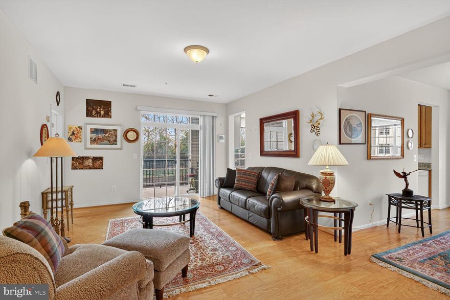 Modern 2 Bedroom Condo with Private Garage in 55+ Gatherings at Ellicott Mills

Sunny and stylish 2 Bedroom, 2 Bath condo featuring a private, enclosed garage in the sought-after Gatherings at Ellicott Mills 55+ community. Built in 2014 and lovingly maintained by its original owner, this home combines modern comfort with timeless design.

Step inside the welcoming foyer and immediately notice the abundance of natural light and open layout. Blonde solid hardwood floors flow throughout the main living and dining areas, creating a bright and inviting atmosphere.

The Gourmet Kitchen is a true centerpiece—offering extensive cabinetry, generous granite countertops, stainless steel appliances, and space for an eat-in breakfast area. A built-in granite desk adds functionality for daily planning or meal prep. Luxury vinyl tile flooring has just been installed for a fresh, modern touch.

Relax and unwind on your private balcony, overlooking peaceful, tree-filled views from the rear of the building—an ideal spot for morning coffee or evening sunsets.

The open-concept Living and Dining Rooms flow seamlessly together, while a custom divider wall provides subtle definition and privacy for the secondary suite area.

The Primary Bedroom Suite is spacious and sun-filled, featuring both a large walk-in closet and a second closet for additional storage. The private en suite bath includes dual sinks, a walk-in shower, and a convenient linen closet. New carpet enhances the comfort and appeal of the suite.

The second Bedroom sits on the opposite side of the home for maximum privacy, with a full bath nearby—ideal for guests or a home office. A laundry room off the foyer provides extra shelving and storage options.

Enjoy direct interior access to your private garage, keeping you comfortable and dry year-round.

Community amenities include a clubhouse, outdoor pool, and beautifully landscaped grounds—perfect for relaxation, exercise, and social gatherings. Conveniently located near shopping, dining, and entertainment, including Walmart, H Mart, Home Depot, and more—all within minutes of your front door.

Experience low-maintenance, resort-style living in one of Ellicott City’s most desirable active-adult communities.
Schedule your private showing today!