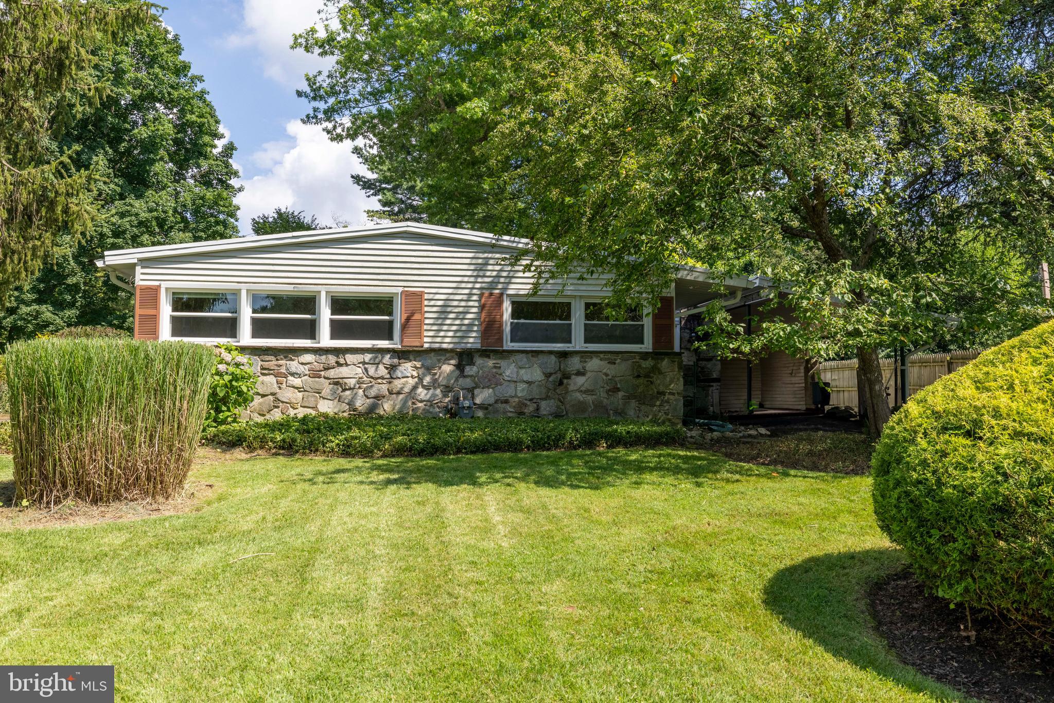 Welcome to this charming ranch-style home nestled in a desirable Ambler neighborhood! Offering convenient one-floor living, this property features 3 bedrooms and 1 full bathroom with a walk-in shower. The inviting living room boasts a cozy fireplace, exposed beams, a ceiling fan, and a large bow window that fills the space with natural light. The kitchen includes a gas range, built-in microwave, ceiling fan, and a window perfectly placed over the sink with a view of the backyard. Outside, enjoy a spacious stone patio—ideal for relaxing or entertaining—overlooking a large, level yard. A private driveway and carport provide ample off-street parking. This home is a great opportunity for first-time buyers, downsizers, or anyone looking for easy living in a convenient location.