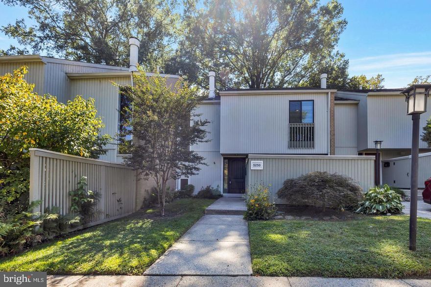 Welcome to 5250 Pooks Hill Rd #B-13, a beautifully maintained 3-bedroom, 2.5-bath townhome located in the highly sought-after Pooks Hill Square community of Bethesda. This spacious and light-filled home offers approximately 2,400 square feet of comfortable living space across three levels. The main floor features hardwood flooring, an inviting living room with a cozy fireplace, built-in bookcases, and charming exposed brick accents. The updated kitchen is equipped with stainless steel appliances, ample cabinetry, and a bright dining area perfect for everyday meals or entertaining. Upstairs, you’ll find three generously sized bedrooms including a primary suite with a private bath and excellent closet space. The finished lower level offers a large bonus room ideal for a home office, playroom, or secondary lounge area, and opens out to a private fenced-in patio—perfect for relaxing or enjoying outdoor gatherings. Additional features include fresh paint throughout, two enclosed outdoor spaces (front and back), and one assigned parking space. Conveniently located just minutes from downtown Bethesda, major commuter routes, Metro stations, NIH, and Walter Reed, this home provides the perfect blend of space, comfort, and accessibility in one of the area's top school districts. Don’t miss the opportunity to live in this charming and quiet neighborhood with everything you need right at your fingertips!