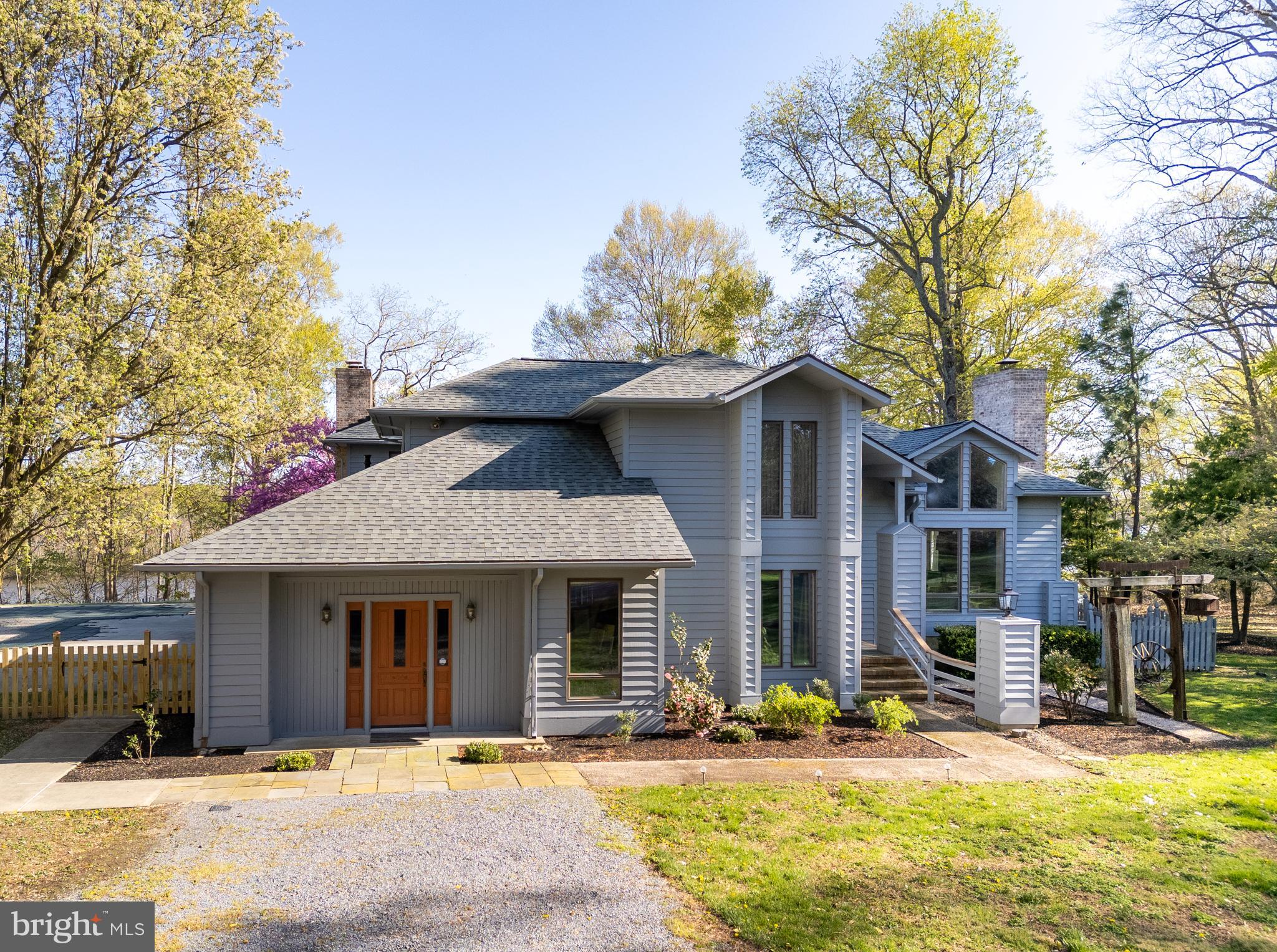 Nestled on over six acres of pristine land with direct access to the Choptank River, this contemporary waterfront estate offers the ultimate in Eastern Shore luxury living. Designed to impress, the home features four spacious bedrooms, three and a half baths, and soaring cathedral ceilings that crown a dramatic two-story living room with floor-to-ceiling windows—flooding the home with natural light and showcasing stunning views of the surrounding landscape.
Perfect for both relaxation and entertaining, the open-concept main living area flows seamlessly into the dining room and a gourmet kitchen equipped with a large center island, custom cabinetry, abundant storage, and a bright breakfast area. Four fireplaces—including one in the cozy family room—add warmth and character throughout the home. A dedicated billiard room with direct outdoor access offers a versatile space that could also serve as an art studio, media room, or more.
The expansive primary suite is a true retreat, featuring a private marble bath, separate workout and tanning rooms, and peaceful garden views. Bedroom flexibility, built-in features, and an upstairs suite with en suite bath offer options for multi-generational living or hosting guests with ease.
Outdoors, enjoy your private, fenced backyard oasis complete with a sparkling in-ground pool and a deep-water dock—ideal for boating, kayaking, or simply soaking in the tranquil beauty of the riverfront setting.
Additional amenities include a detached garage with a second-floor loft perfect for storage, studio space, or a workshop, and a separate shed for tools and equipment. Located just outside the town of Denton, you’re only minutes from charming shops, dining, and state parks, all while enjoying the privacy and serenity of a secluded waterfront lifestyle.
This is a rare opportunity to own a truly remarkable Eastern Shore property where luxury meets nature.
