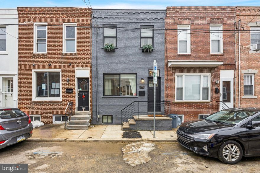 Absolutely stunning & fully renovated 2-bedroom, 1-bath home offering over 1,200 square feet of total living space (including a beautifully finished basement). Nestled on a quiet, tree-lined street just steps from East Passyunk Avenue — this home combines location, style, and quality craftsmanship in one irresistible package. From the moment you step inside, you’ll notice the thoughtful design of this home. The wrought iron staircase is set farther back, creating an unusually spacious and inviting living room — perfect for oversized, comfy furniture and effortless entertaining. The neutral palette, stylish hardwood flooring, natural wood accents, and open, airy layout create a warm and welcoming atmosphere throughout. The kitchen is absolutely stunning with two-tone cabinetry, quartz countertops and island, stainless steel appliances, and chic gold and black fixtures. Just off the kitchen, the private patio offers a fabulous outdoor retreat — ideal for dining al fresco or simply unwinding at the end of the day. Upstairs, you’ll find two generously sized bedrooms and a beautifully appointed full tile bath featuring a gorgeous marble vanity and built-in shelving. The finished basement provides valuable additional living space with recessed lighting, tile flooring, and a dedicated laundry area with extra cabinet storage — making it the perfect flex space for a second family room, home office, or gym. Conveniently located just blocks from the Broad Street Line, this move-in ready showstopper truly checks every box. This home is an absolute must-see in one of Philadelphia's most vibrant neighborhoods!