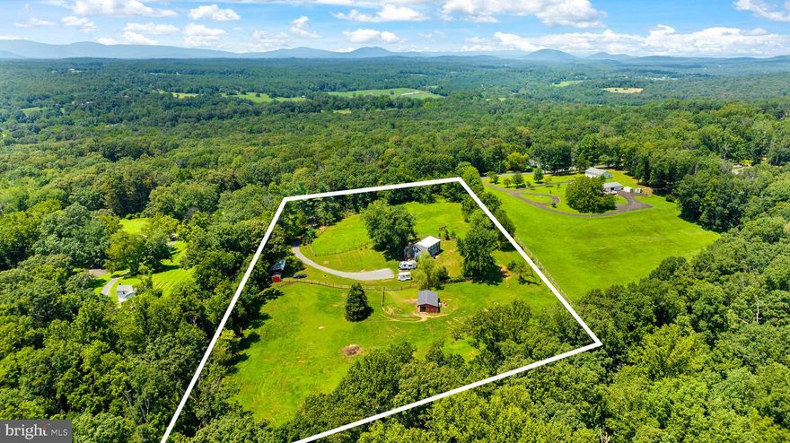 Surrounded by trees on nearly 5 landscaped, park-like acres, this charming Cape Cod is a rare offering in the heart of Virginia's hunt country. This turn-key property has been thoughtfully curated around enjoying having horses at home. The house sits in the center of the property, with gently rolling pastures out every window. 

Inside, you’ll find an inviting, open-concept floor plan with vaulted ceilings, floor-to-ceiling windows, wide-plank hardwood floors, and a gourmet kitchen outfitted with granite counters, stainless steel appliances, and custom cabinetry. The home features 3 bedrooms and a bonus room. 

The spacious primary suite includes a large full bath and walk in closet and is conveniently located on the main level behind French doors. An additional pair of French doors across the hall takes you straight into the charming back yard. 

Upstairs, you'll enjoy an open loft before discovering two generously sized bedrooms, each with ample closet space. A full bathroom sits between them, and just across the hall, a spacious bonus room offers even more flexibility—perfect for a guest room, play space,  office or home gym. 


The property is already set up for horses, featuring a gated driveway with a fully enclosed perimeter, two large split-rail fenced pastures, and a shed row barn with two stalls, a tack room, and an attached small paddock. An additional equipment shed provides storage for tools or machinery, while a hay and tractor shed tucked into the treeline offers natural shade and could easily double as a run-in shelter.
There's a lovely ride-out through the quiet neighborhood with direct access to gravel Cliff Mills Road—perfect for peaceful hacks. An Invisible Fence is installed around the yard (excluding the pastures), and collars will convey with the sale.
Modern conveniences include a 50 AMP camper hookup and high-speed Starlink internet, already installed and transferable to the new owner—ideal for remote professionals. Commuters will appreciate being just an hour and ten minutes from MetroCenter via the I-66 express lanes.
Located only 15 minutes from Old Town Warrenton, the property is also a quick drive to Shenandoah National Park and a scenic ride away from some of Virginia’s finest wineries and equestrian trails. Zoned RA and offering 4.9 acres of usable land, this 2,312+ square foot home combines rural charm with everyday comfort—no HOA, well and septic included.
Equestrians will also love the proximity to Warrenton Hunt and Old Dominion Hounds kennels, with Rappahannock and Thornton Hill fixtures nearby.