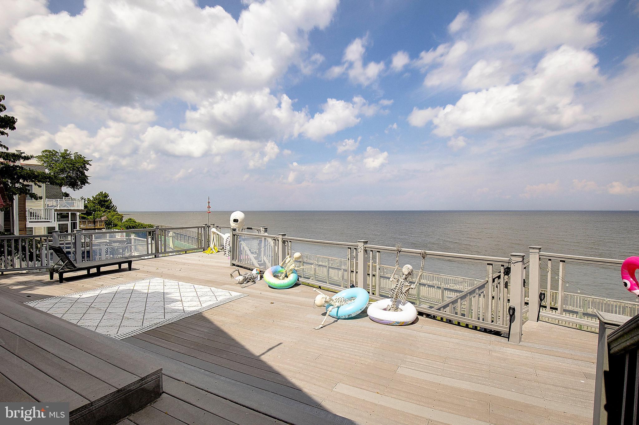 Waterfront 2 bedroom, 1 bathroom cottage on the Chesapeake Bay. Enjoy stunning water views with brilliant sunrises right from your large deck! Entertain & invite your friends, family, neighbors! Located in the heart of Chesapeake Beach you can walk to the local Bayfront Park beach, stroll down to local entertainment/food/marina, and so much more. Double lot, fenced, paved patio, shed & outside entrance to usable basement (laundry, additional storage). Open floor plan inside with sun room, numerous sliders to deck. Partially furnished!