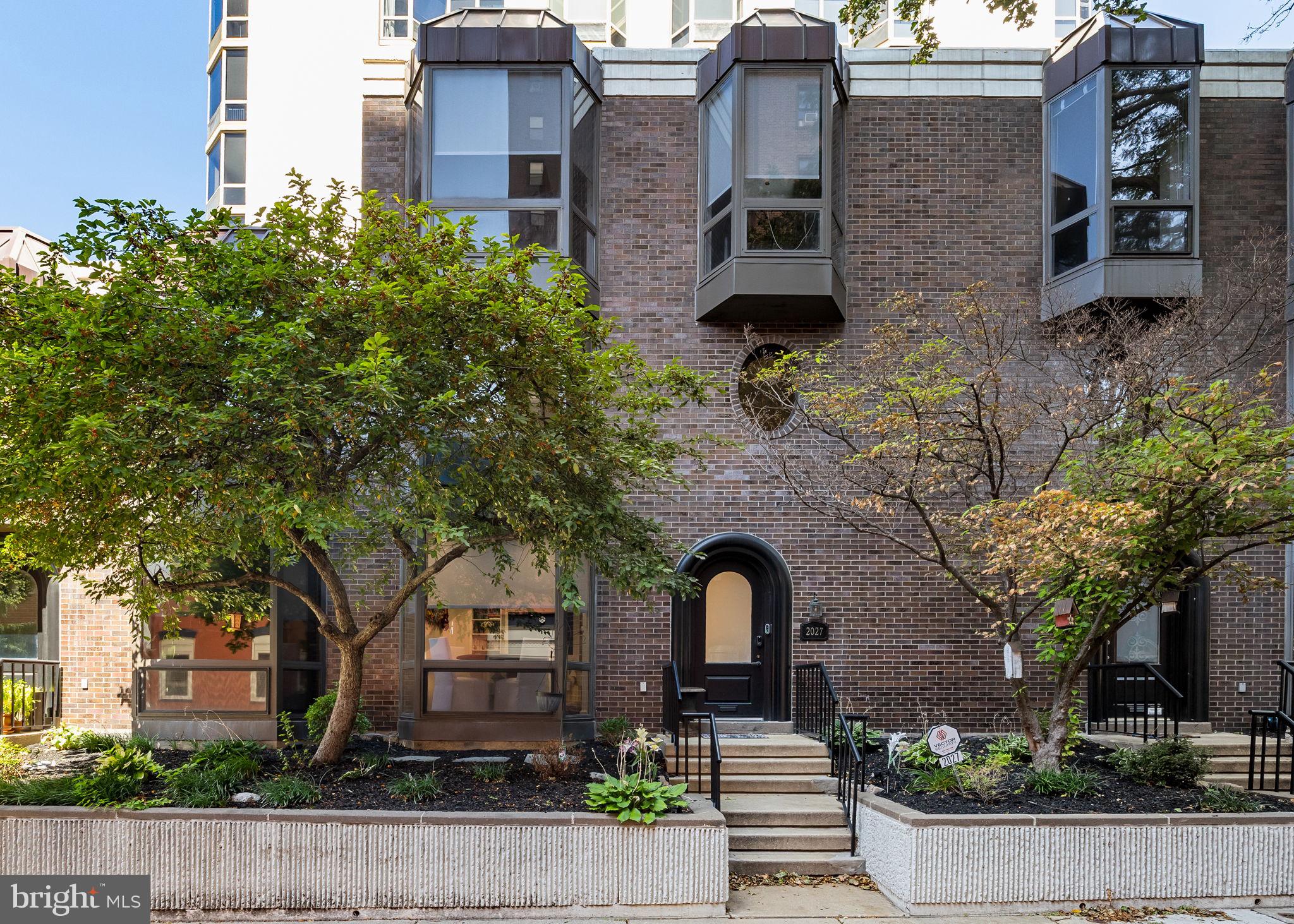 Townhouse privacy meets condominium amenities in this beautifully updated three-bedroom, two-and-a-half bathroom Wanamaker House townhome featuring three levels of sun-kissed living space and a prized Rittenhouse Square location just steps from the namesake park.
Inside this 1,900-square-foot residence, soaring ceilings with recessed lighting, lovely new flooring and expansive floor-to-ceiling windows create a bright and airy ambiance throughout. Charming forecourt gardens and an arched entry door welcome you into a gracious foyer with a custom wardrobe. Ahead, the spacious living/dining area invites you to relax and unwind alongside a wall of built-ins, an electric fireplace, and a dramatic bay window framing views over quiet and quaint Chancellor Street. The updated open kitchen impresses with abundant storage, new countertops and tile backsplashes, a breakfast bar and new stainless steel appliances, including a glass range, side-by-side refrigerator, and dishwasher. A lovely powder room completes the well-planned main level.
Head upstairs to find the full-floor primary suite featuring a king-size bedroom with a bay window and an oversized custom walk-in closet with double hanging rods, shelving, and drawers. A seeded glass door opens to the en suite spa bathroom that boasts a jetted soaking tub, frameless glass shower, and double marble vanity topped by an illuminated mirror. On the top floor, two spacious and sunny secondary bedrooms share an updated full bathroom with a large tub/shower and a vanity with generous countertop space and drawers.
Central HVAC, additional closet space, and a new in-unit washer-dryer add exceptional convenience. This home also offers direct access to the Wanamaker House’s park-and-lock garage. A parking spot, conveniently located right outside the townhouse’s back door, is available for purchase for an additional fee.
Residents of the rarely available Wanamaker House townhomes enjoy full access to the adjacent condominium tower’s elite amenities, including 24-hour doorman service, package receiving and storage, a residents’ lounge, a state-of-the-art fitness center, and the wonderful rooftop pool and sundeck.
From this outstanding location within the Rittenhouse/Fitler Historic District, you’re surrounded by the coveted neighborhood’s hundreds of renowned restaurants, nightlife venues and shops. Enjoy immediate proximity to Philadelphia’s best historic sites, museums, universities, Schuylkill River Park, Center City amenities, and top-rated schools. Nearby PATCO stations, 30th Street Station and Philadelphia International Airport provide easy access to the rest of the city or wherever your next adventure takes you.