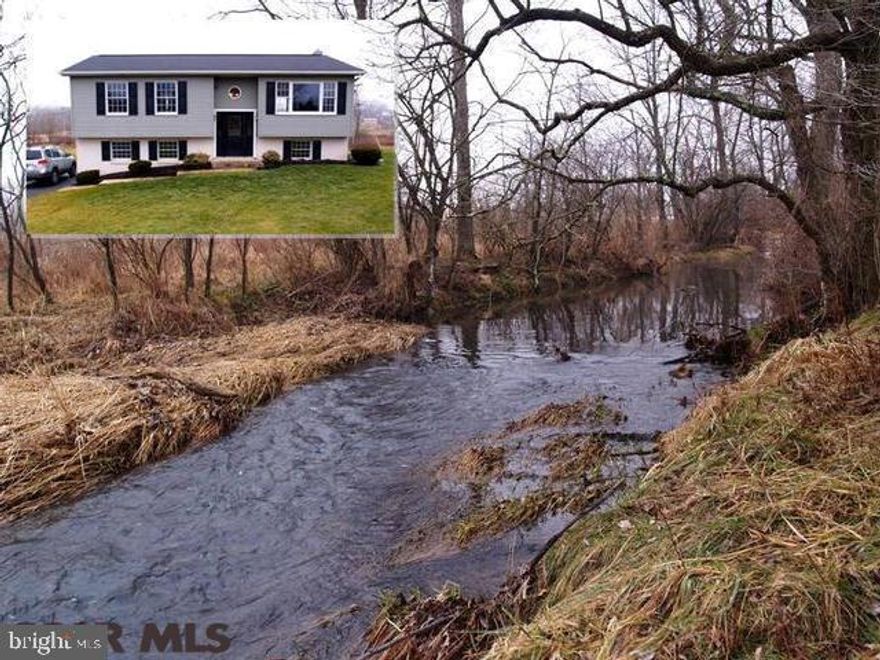 Over an acre of land with pastoral views and a flowing fishing stream at the edge of property. Watch grazing horses from your rear deck. New carpet & vinyl installed on the main level. Flue for wood stove in the bright family room. Looking for a home with in-law space or room for your college kid to come & go, this is your home. A ton of clean bright space for an affordable price. The large mainly level yard awaits your outdoor activities, gardens or pool. According to maps, only the back portion of land is in flood plain. Home does not appear to be in flood plain. Buyer should verify flood plain status.