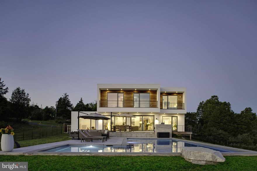 Passionately designed by the progessive company, evoDOMUS, to surpass all conventional expectations of a residential home, both visually and functionally. This award-winning team of engineers and designers combine superior design elements along with sound, environmentally conscious choices to save resources and eliminate the use of fossil energy sources. Walls of Unilux triple pane windows integrate natural light throughout this extraordinary home to capture every vantage point of this beautiful Bucks County site, surrounded by panoramic views of the horizon. Healthy both outdoors and in, inhabitants are surrounded with a re-circulating fresh air environment. Initial assembly of the fabricated modules was in a facility with a dry, controlled environment which allowed the structure to be delivered in superior condition over traditional methods with materials being exposed to the elements at the building site. All designs and systems are super energy efficient to minimize the ecological impact, while at the same time creating the added benefit of unbelievably low utility costs. Another great feature for future energy efficiency is a conduit to the roof to enable a future roof installed photo voltaic system to make this home a Net Zero home! This simply spectacular home offers over 4400 sq.ft. of living space with clean, sleek lines that integrate views of the surrounding flora and fauna. The kitchen features a waterfall peninsula and top of the line appliances. The adjacent dining room is perfect for entertaining purposes, and opens to the living room with a double-sided fireplace with a ventless bio-ethanol insert, clad in Dekton quartz panels. A first floor den with custom built in storage completes the first floor along with the half bath.  Ascend to the second floor with a wall of windows over looking the entry and floating staircase.  The second floor gallery area with half wall and continuous views leads to the generous primary bedroom suite with decadent bathroom featuring soaking tub, dual vanities and oversized steam shower plus a spacious walk in closet (13 x 9). Two additional bedrooms and a hall bath complete the second floor. The walk-out lower level reveals a luxurious cedar spa/sauna with guest room and full bath. You will also find the exercise/all purpose room and media room as well as a large laundry area with cabinets and storage. Large sliding doors connect the living spaces with the surrounding landscape where outdoor living is paramount. The deck and surround provide a unique outdoor living experience with ample sitting spaces and stunning views that extend far beyond the contemporary pool with tanning ledge and patio surround. Located within a few miles radius of countless golf courses, parks and recreation. Only a 5 minute drive into Historic Doylestown with boutiques, restaurants, museums and cultural events. Reach New York and Philadelphia easily from this terrific location! This home is part of the distinguished Central Bucks School District, as well as many prestigious private schools in the area as well. Conveniently located minutes from Route 611, with easy access to Route 202 and other major commuter routes. Unique and special opportunity - call today!