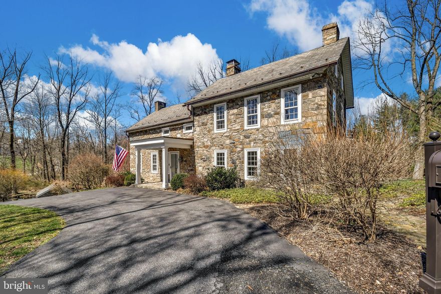 A peaceful rural road winds its way to a preserved stone farmhouse and exceptional Pennsylvania bank barn set on ten picturesque acres. Built circa 1750, Starry Night Manor preserves the artisanship of a bygone era yet expertly blends today’s conveniences for a contemporary lifestyle.
     The home offers three sunlit bedrooms and three modern bathrooms in a floor plan where original random width floors, deep silled windows, and exposed wood beams remain. High ceilings, a walk-in fireplace and built-in shelves accent the spacious dining room and living room. A cathedral ceiling, island with seating and radiant heat floor enhance a sparkling kitchen. Steps away, an expansive bluestone patio with wisteria laced arbor and built-in hot tub is the perfect spot for relaxing and entertaining throughout the seasons.
     Brimming with natural beauty and buffered by quiet woodland, the grounds invite exploration with a spring-fed pond, lofty trees, and flowering gardens. Centuries old, the thoroughly charming springhouse is freshly renovated and climate controlled, ideal office or studio space.
     A turnkey weekend retreat easily reached from Manhattan and Philadelphia or a full-time residence with great access to I-78 and destinations in the Lehigh Valley, Starry Night Farm delights with modern touches and preserved history.