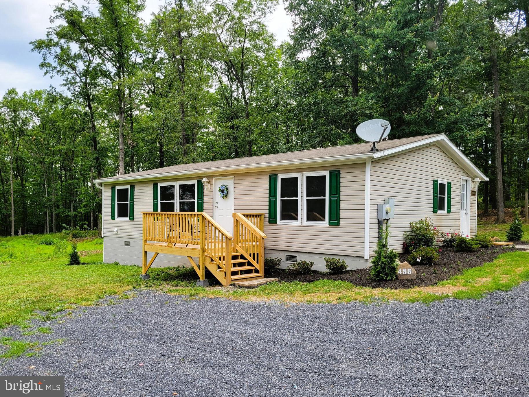All new 30 year Architectural roof shingles and 200 amp electric panel just installed...Nearby woodland retreat located in secluded, wild wonderful West Virginia. Perfect for a permanent home or weekend vacation spot where wildlife abounds. Owner has extensively remodeled this 1200 square foot manufactured rancher with 3 bedrooms and 2 full baths. New heat and AC system, new Windows, New Paint throughout Home with all New Lighting Fixtures, new Kitchen Appliances and new Kitchen Cabinets/Countertop/Sink, new hot water heater, new electrical outlets and switches and the bathrooms have been completely updated with new fixtures. A new front deck has been added along with extensive landscaping. WV state maintained road and no HOA fees. Close to towns like Wardensville, Capon Bridge, Moorefield etc with shopping, restaurants, farm markets and many tourist attractions. Seller states Utilities as follows...Elec, Potomac Edison, Phone/TV/Internet is Frontier, T-Mobile Home Internet, Dish Network and/ or Direct TV.