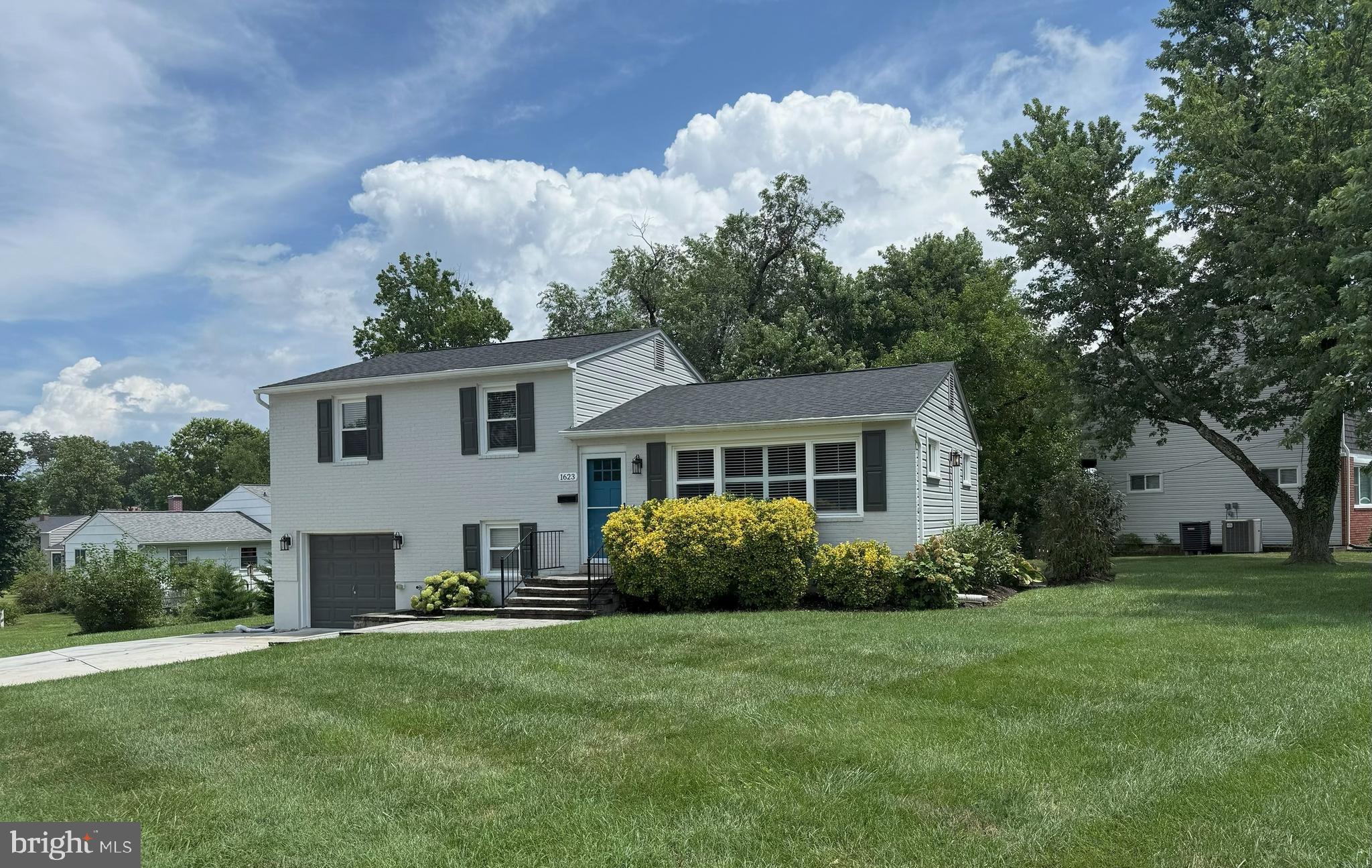 Fully renovated 4 bedroom, 3 bath on a corner lot in desired York Manor community. Quality renovation from top to bottom in 2019 (including reshingled roof) with tasteful and modern finishes. Instant curb appeal as you approach with professional landscaping, recently expanded concrete drive leading to front load garage, and beautiful stone walkway. Open and bright main level boasts gorgeous hardwoods, spacious gourmet kitchen with stainless steel appliances (new stainless refrigerator in 2025), textured granite counters and tons of cabinetry. Kitchen opens to a natural light-filled living room with great space. Upper lvl with 3 bedrooms, hardwood floors, hall bath with bath/shower combo and separate owner's bath with gorgeous tilework and stylish vanity. Lower level includes a gorgeous and functional mud/laundry area with built-ins, washer/dryer, cabinet storage and laundry sink. Convenient mudroom entry right off of garage. Lower level also includes a spacious room with hardwood floors, a walk-in closet, plus a spacious full bath with double vanity. Endless possibilities to use the lower level as a rec rm, family rm, additional bedroom or luxury home office. French doors from lower level allow an abundance of sunlight and rear exterior patio access. This one is turn-key and thoughtfully designed, won't last long!