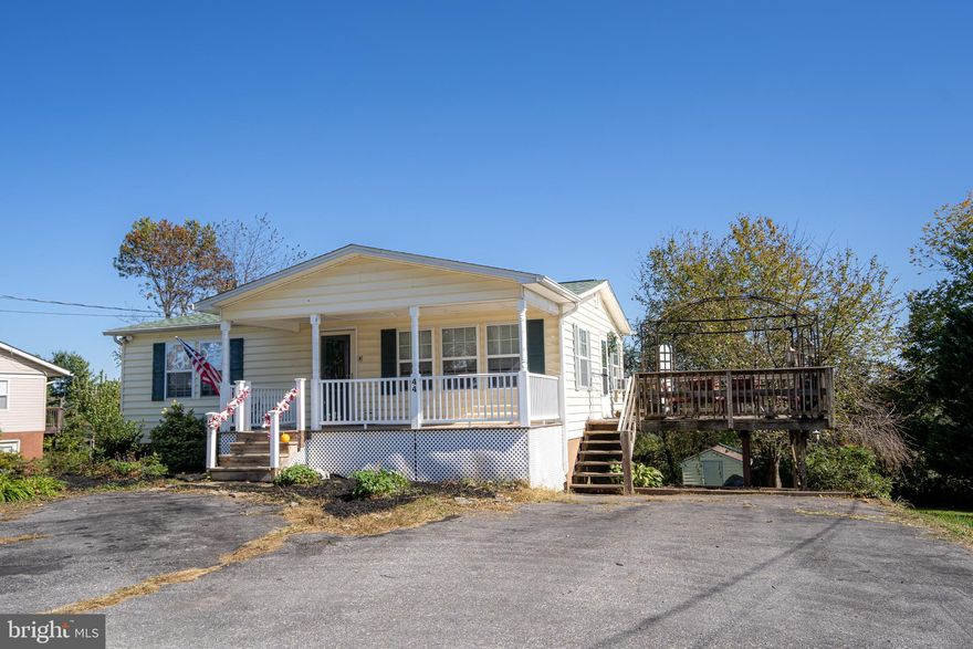 This cozy rancher features 3 bedrooms and 1.5 baths. Lots of living space with the finished basement. Paved driveway affords off street parking for multiple vehicles. Living room with easy care laminate, spacious kitchen with LVP floors and updated appliances. Kitchen side door takes you to large deck with stairs to the driveway, also great for outdoor entertaining and enjoying meals outside. Large primary bedroom and 2nd bedroom on main level. The hall bath features single bowl white shaker vanity and medicine cabinet. The walk-in shower features a tile surround with storage nook. A large linen closet on this level provides extra storage. The lower level of the home is finished with rec room. There is an area with ceramic tile floors perfect for a craft room, and third bedroom is on this floor. Good sized laundry area, walk out to a concrete patio with storage shed. Yard is mostly level and lush with grass with ample space for gardens, play areas, and a firepit if desired. There is another shed for storage plus room under the deck for river toys, bikes, etc.  Property is convenient to shopping, restaurants and easy for commuting with WV Rt 9, 340, 115 nearby, along with parks and facilities for events.