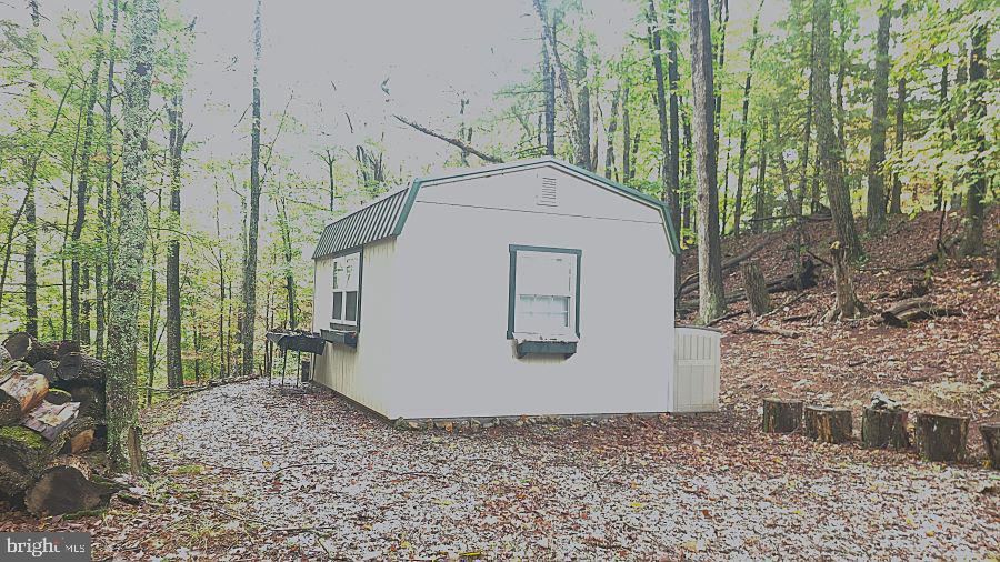End lot available in Sugar Grove Estates development. Secluded, wooded lot sloped, but with some level areas for building site. Lot has been perked, Electric close by. Excellent hunting. Gated development. HOA restrictions apply.