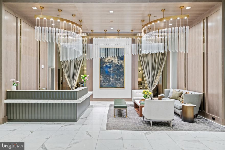 The Ritz-Carlton Residences, Chevy Chase are the epitome of luxurious living. The building offers paralleled services to Ritz hotels worldwide, with exceptionally high standards and modern-day conveniences. The building provides highly desirable Class A amenities including a valet, doorman, 24/7 concierge, porter service, onsite management, onsite building engineer, free building-wide wi-fi, fitness center, multiple club rooms, catering kitchen, and outdoor entertaining spaces with grills, seating areas, and fire pits. No detail was overlooked in the masterful construction of these high-end residences, which include the highest quality fixtures and finishes throughout. Building features such as solid-core doors, solid-wood window and door casings, wide plank white oak floors, and recessed LED lights are found throughout the unit. The residences are also easily accessible to retail, restaurants, the Capital Crescent Trail, and Metro. This spectacular third floor residence is filled with an abundance of natural sunlight from oversized windows throughout. The unit provides over 1,900 square feet of open living space and features two spacious bedrooms, two and half bathrooms, and a den. The entry hall provides easy transition to the main living spaces, including direct access to the well-appointed kitchen. The kitchen features Stevali imported fine Italian solid wood cabinetry, a peninsula with a breakfast bar, and a top-of-the-line Bosch appliance package. The kitchen opens to the living room and dining room, which is graced with a beautifully lit tray ceiling. There is also the added convenience of a nearby powder room. Continue to the den, which can be fully closed off with pocket doors and accesses the private balcony. The luxurious primary bedroom captures beautiful sunlight and has a large walk-in closet with an Econize closet system. There is also a spa-inspired Carrara marble en-suite bathroom with dual vanities with quartz countertops, a frameless glass shower, and a separate tub. There is an additional bedroom with a double door closet and an en-suite bathroom, as well as a laundry room with quartz countertops, shelving, and cabinetry. The unit also includes a storage unit and two parking spaces with EV capacity.