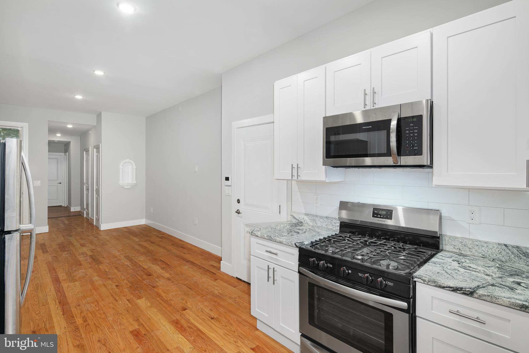 Be the first to live in this beautiful 2-bedroom apartment with private outdoor space! Enter into the open-concept kitchen plus living room. The kitchen is sure to please, outfitted with white shaker cabinets, stone countertops, and stainless steel appliances. The high ceilings and numerous windows brighten up the room and make it the perfect space for entertaining. Down the hall, on the way to the bedrooms, there is a convenient powder room and coat closet. The first suite is a large bedroom and 3-piece bath, including a new vanity and walk-in shower with modern tile surround. The huge lower-level bedroom gets incredible light from the expanded window! There is another half bath, the washer & dryer, and a large storage room off this bedroom. Primely located in the booming Graduate Hospital neighborhood, this unit is just steps to plenty eateries and nightlife with every public transit option allowing quick access to Rittenhouse Square, Fairmount, Old City, and South Philly.