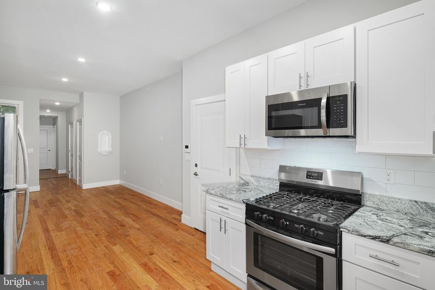 Be the first to live in this beautiful 2-bedroom apartment with private outdoor space! Enter into the open-concept kitchen plus living room. The kitchen is sure to please, outfitted with white shaker cabinets, stone countertops, and stainless steel appliances. The high ceilings and numerous windows brighten up the room and make it the perfect space for entertaining. Down the hall, on the way to the bedrooms, there is a convenient powder room and coat closet. The first suite is a large bedroom and 3-piece bath, including a new vanity and walk-in shower with modern tile surround. The huge lower-level bedroom gets incredible light from the expanded window! There is another half bath, the washer & dryer, and a large storage room off this bedroom. Primely located in the booming Graduate Hospital neighborhood, this unit is just steps to plenty eateries and nightlife with every public transit option allowing quick access to Rittenhouse Square, Fairmount, Old City, and South Philly.