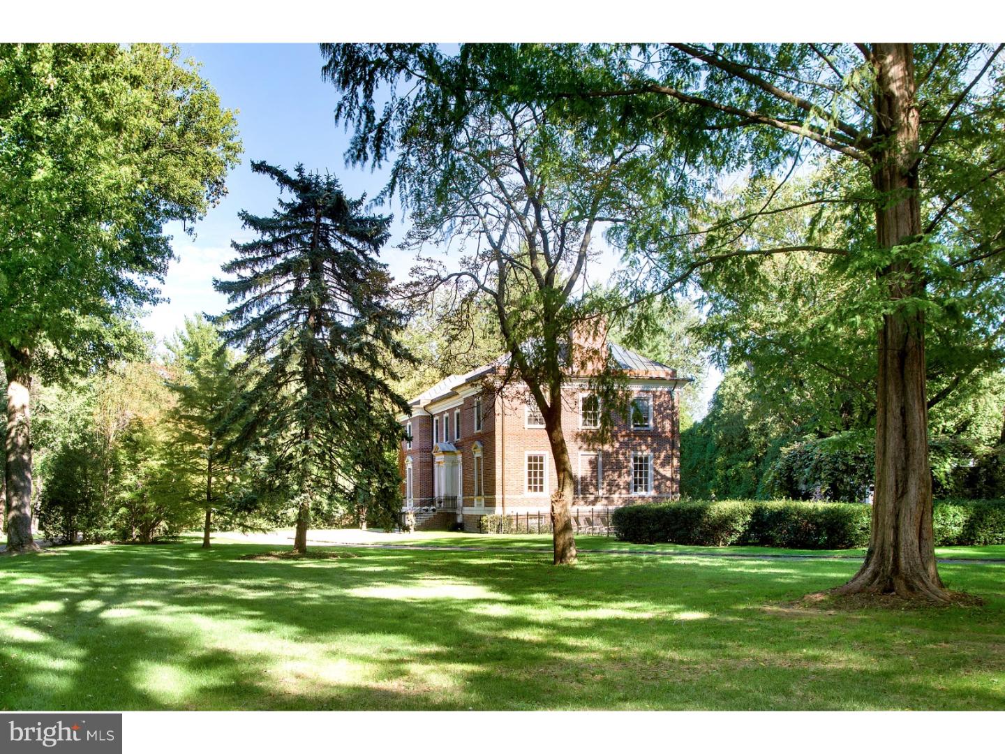 Tucked down a long winding private drive, Craig Hall is both formal yet livable at the same time. An exceptional residence with historic significance, it has been lovingly maintained and modernized over the years to become a one-of-a-kind home for family living and entertaining. This stately red brick English Georgian estate designed with stone exterior wall construction and graced with brick exterior walls, terracotta block interior walls and Samuel Yellen ironwork in both interior and exterior was created by renowned local architect Horace Trumbauer, who built for Philadelphia's most elite families as well as The Phila Museum of Art. Craig Hall was commissioned in 1924 by Katherine Craig Wright Muckle, the granddaughter of merchant Hugh Craig and her husband John Seiser Muckle, son of longtime manager of the Public Ledger newspaper. Its timeless Georgian style is complemented by striking neoclassical touches such as limestone detailing, while steel joists and concrete construction attest to an unquestionable level of quality. The breathtaking grounds offer gardens & lawn areas for play, along with a swimming pool and pool house (both added in 2007) with a kitchenette, bath and laundry faculty for entertaining convenience. The current owners have thoroughly enjoyed the setting for all occasions, whether hosting parties for 120, gatherings, or formal dinners in one of many private areas. No expense was spared in restoring this testament of architectural integrity to its original splendor. Upon entering you are instantly impressed by the caliber of elegance, voluminous ceilings and light-filled ambience. The main level welcomes you with a marble entrance hall. All major first-floor rooms were restored to their original design with modifications made to facilitate a contemporary lifestyle. A magnificent Yellen-designed white marble staircase with ironwork railing curves gracefully up to the completely new 2nd floor that beautifully adheres to period tradition, with early 20th-century details including wainscoting, door and window casings and quarter sawn white oak throughout, all custom milled. New BRs and baths include a blissful master suite. The lower level renovation retained the original form of the billiards and pub/card rooms. A 1,100-bottle wine cellar, au-pair suite, gym, home theater with surround sound and mudroom were added to optimize the allure.