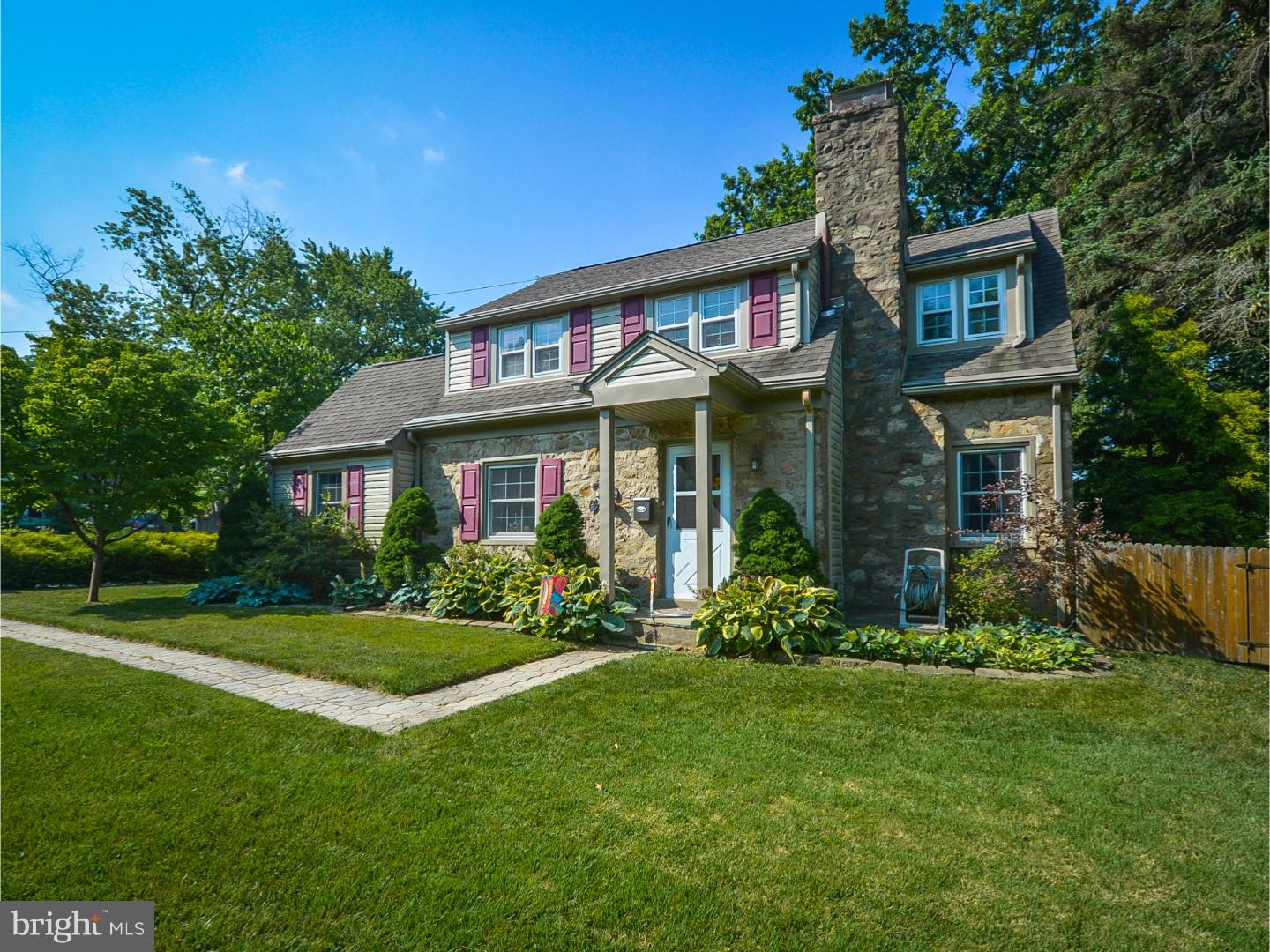 Gorgeous, Charming & Well-Built Stone Colonial on a corner property with tremendous curb appeal! Located in sought-after Springfield Township, this property has lovely landscaping & fabulous fenced-in expansive yard w/flagstone patio/walkway, fire pit & gazebo?fantastic for entertaining or a private retreat! This three bedroom, two bathroom home boasts abundant character, including handsome hardwood floors throughout, replacement efficiency windows, central air, wrought-iron hardware on interior doors, premium bamboo floors in office & master bathroom, and darling deep window sills. Highlights: First Floor? Large Living Room has a stone, wood burning fireplace w/mantel, beautiful built-in bookcases, and high hats; Delightful Dining Room offers custom wainscoting & the sophisticated, home or remote controlled, weather smart, Emme Core Energy Management Platform with multiple room sensors; Multipurpose Room off of Dining Room can be used for Office, Exercise, Play, Arts & Crafts, or anything! Kitchen provides gas cooking w/exhaust fan, double composite sink w/pull out faucet, garbage disposal, plentiful Maple cabinets, dishwasher, new recessed LED lights & dimmer switches, wiring for multi-room audio system (music for cooking/entertaining!), tile backsplash, ceramic tile floor, and door leading to driveway, backyard, and one-car attached garage (new insulated steel garage door, 7/16). Second Floor?Spacious Master Bedroom consists of two closets, ceiling fan w/lights, and master bath w/stall shower & linen closet. Second Bedroom includes a ceiling fan w/lights, closet, and attic access (pull-down stairs w/insulated access cover to storage platforms; R30 insulation throughout? also in crawl space & garage ceiling!). Third Bedroom features a ceiling fan w/lights and double closet & single closet. Hallway: an all-tile bathroom including tub w/overhead shower, single sink vanity w/new faucet, and wainscoting, plus a separate linen closet. Other assets: unfinished basement w/washer & dryer hook ups, wiring for multi-room audio system, laundry tub, waterproofing, whole house humidifier, new Bradford-White hot water heater (7/15), and upgraded Liberty sump pump with Sump-Jet water powered backup system; 3-car driveway; paver walkway to front door; storage shed (as-is); 200 amp service. Purchase includes a One-Year HMS Home Warranty?for added piece of mind! Due to the marvelous move-in condition, Buyer will be able to enjoy this peaceful paradise on Day 1!