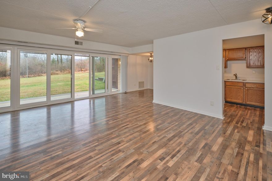 Charming First-Floor Condo in Hermitage – Prime New Hope Location. This pristine first-floor condo in the desirable Hermitage community offers comfort, convenience and a prime location just minutes from shopping, dining, and entertainment in the heart of New Hope, Solebury; Peddler’s Village in Lahaska is just a 5-minute drive away. The spacious one-bedroom unit features new floors, a large bedroom with ample closet space, an adjoining full bath, and in-unit laundry. The open-concept living and dining area is filled with natural light from oversized windows. The brand new 8 ft  sliding glass doors lead to a private covered patio with a storage shed, overlooking a serene landscape. Assigned parking spot plus ample guest parking.  Outdoor amenities include serene grounds and outdoor pool. Don't miss this opportunity to live in a peaceful, well-maintained community close to everything New Hope has to offer!. This one will not last. Set up a showing today!