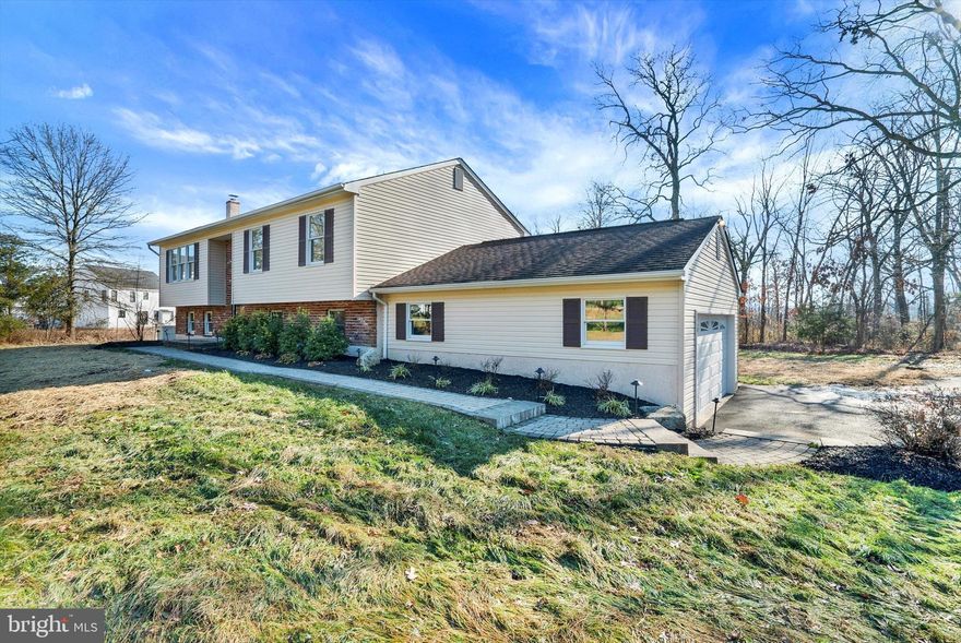 This traditional style Colonial home embodies the serenity of  Bucks County yet offers a unique sense of community and belonging with the neighboring homes.  The home sits upon 2.181 acres of land in Plumstead Township and Central Bucks School District. This home hosts seven rooms. The kitchen has been recently renovated.  White crisp kitchen cabinets, tile backsplash, granite counter-tops, white Blanco farm-house sink, wood floors, pantry, freshly painted and new lighting.  The breakfast room is adjacent to the kitchen with new lighting and glass sliding doors that lead out to the deck.  The inviting living room is large in scale with a wall of windows, new flooring and fresh paint.  Down the hall you are greeted with two generous sized bedrooms both with ample closet space, new flooring and fresh new paint.  Both secondary bedrooms share a full hall bath.  The main bedroom offers new flooring, generous sized closet, fresh new paint, new ceiling fan and a full bath.  The family room is located on the lower level of the home.  It showcases exposed beams, a handsome wood burning fireplace, rustic wood trim, new carpet and fresh new paint.  Off of the family room is a large bonus room with custom built ins, half bath, laundry room, bar area and private entrance.   The grounds are beautiful with paver walkways, exterior lighting, planting beds, large paver patio and a park like setting of beautiful land and views.  A shed for additional storage, a generator, gas line for your grill, and a  two car garage that completes this home.