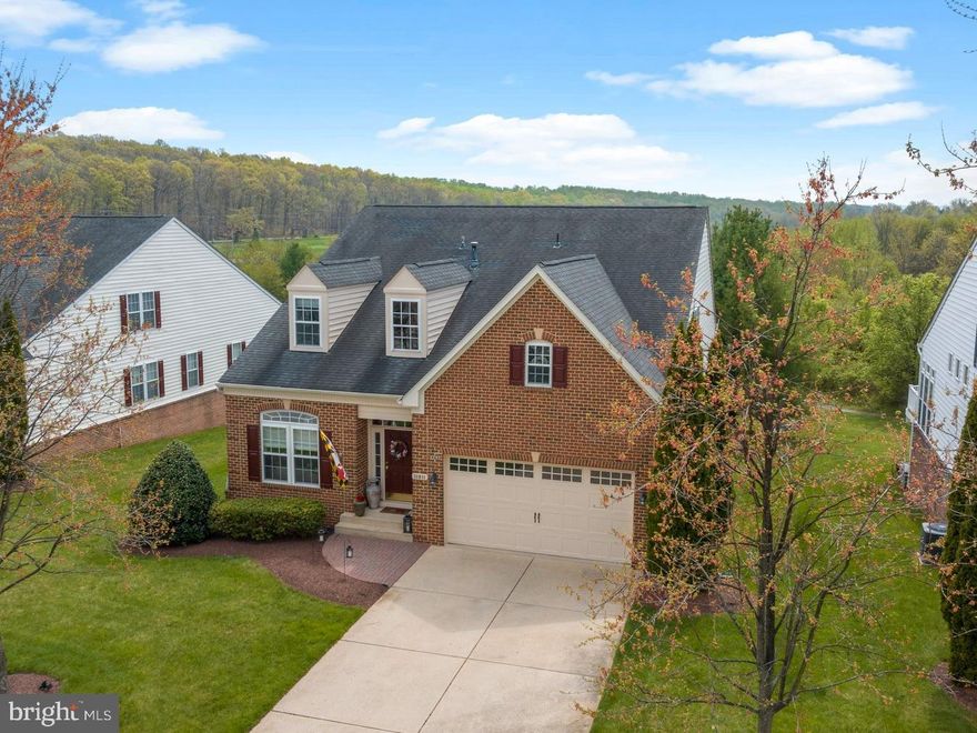 Welcome to your dream home - nestled in the serene 55+ community of Ellicott Meadows, offering easy, care-free living and an array of exceptional amenities. This villa is situated on one of the best lots in the community – located on a cul-de-sac and backing to open space with views of the community pond! Step inside and you are greeted by the inviting open floor plan with gleaming hardwood floors throughout that seamlessly connect the main living spaces. Wonderful features include a welcoming foyer, living room with bay window and dining room accented with a tray ceiling adding to the room’s ambiance. The huge open kitchen has a breakfast bar, stainless steel appliances, double sink, granite counters, tile backsplash, gas cooktop, double ovens, butler’s pantry, large walk-in pantry and a breakfast area that provides a comfortable space for more relaxed meals. The dramatic family room, adorned with a gas fireplace and soaring ceilings, creates the perfect atmosphere for gatherings plus the adjacent sunroom provides a peaceful retreat. The main level owner’s suite boasts a tray ceiling and oversized walk-in closet with organizers plus a beautifully updated ensuite bath that exudes luxury, complete with heated floors & towel rack, water closet, double sink vanity and extra wide shower with bench, tile surround & frameless glass doors. The main level also offers an additional bedroom that adds flexibility to be a guest room or office plus there is a full bath and a laundry room with cabinets & exit to garage. Upstairs is the perfect place for guests with 2 bedrooms (1 with walk-in closet), Jack and Jill bath, lots of closet space plus a cozy loft overlooking main level! The basement is unfinished but offers an atrium door walkout, bath rough-in, laundry tub (easily converted to a wet bar) and endless possibilities! Outside offers maintenance-free living with brick front, vinyl siding and expansive deck with beautiful views! Parking is easy with 2 car garage plus concrete driveway. Fantastic community amenities include clubhouse, swimming pool, fitness room, tennis court, pickleball court, community events and clubs plus lots of walking paths. The roof is also covered under the condo fees! This is the perfect location - just minutes to commuter routes, parks and shopping!