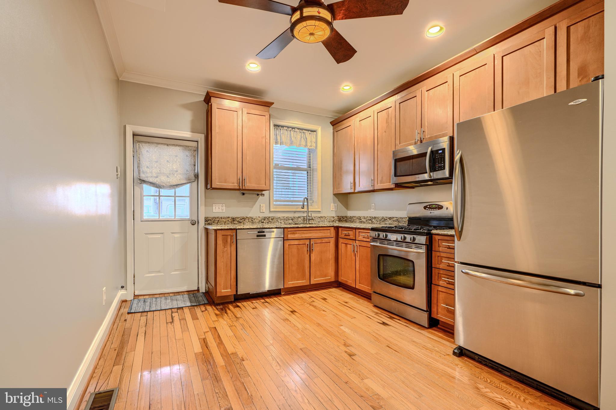Located in the heart of Locust Point, 1413 Hull St offers a large footprint at an affordable price! Featuring a fully finished basement, open floor plan and parking potential, this 2bd/2.2ba historic rowhome checks every box on a buyer's wish list! The main level is spacious and open and offers gleaming hardwood floors throughout. There's ample room for all of your furniture and entertaining needs in this open floor plan. The living/dining room combo opens nicely to the kitchen, which provides granite countertops, stainless steel appliances and plenty of cabinet space. There's also a powder room for added convenience and access to the private fenced-in patio. A private parking pad could be added if the fence is removed, a rarity in the neighborhood. Upstairs offers a spacious guest bedroom with large closet and plenty or room for a king-sized bed, plus a guest bathroom with shower/tub combo. The primary suite is enormous and can easily fit a king-sized bed, plus has access to the ensuite bathroom. The rear bedroom provides access to the rooftop deck, which has been recently overhauled and offers panoramic views of Baltimore City. The basement is fully finished and provides ample storage space and a bonus room for entertaining guests, use as a home office or a home gym. Plus, there's an additional half bathroom. With a recently updated roof (1 year warranty conveys to new buyer) and updated utilities, this Locust Point home is truly turnkey and is ready for its next owner!