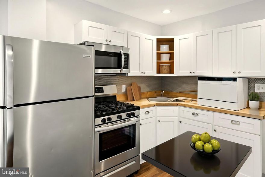 This beautifully updated 3-story home is move-in ready and waiting for you! With modern touches throughout, you'll love the bright and airy living spaces. The kitchen is a highlight, featuring white cabinetry, butcher block counters, and new appliances. Upstairs, the second floor offers two spacious bedrooms and one full bathroom, while the third floor boasts a serene master bedroom with high ceilings and wood beams. The finished basement offers additional living space and storage. Recent upgrades (2021) include a new washer and dryer, water heater, and heating system. Plus, enjoy the convenience of two parking spaces in the back and easy access to I-95, restaurants, shopping, and public transportation. Don't miss out on this fantastic opportunity - schedule a showing today!