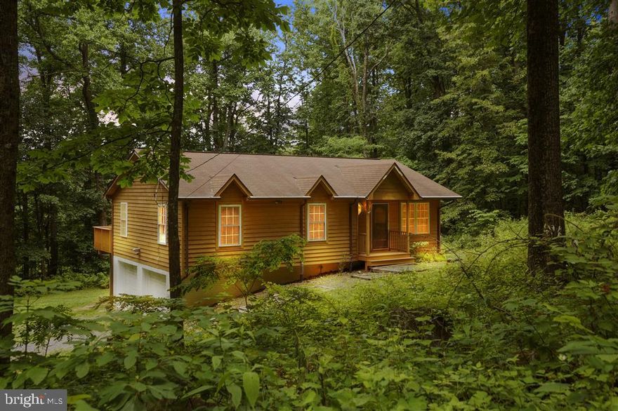 Fully furnished with hot tub, this stunning 1.33-acre corner lot home has been fully renovated in 2023. Originally built in 2003, upgrades include a brand-new HVAC system, full house water filtration, hot tub with warranty, new kitchen appliances, and overhauled septic. This smart home features a Nest system with thermostat, front door deadbolt, and driveway camera with floodlight for convenience. Enjoy refinished hardwood floors upstairs and new luxury vinyl flooring downstairs, plus a gas fireplace. Outdoor amenities include a detached storage shed, kids swing set, and a spacious deck with seasonal views (or trim the trees for a year-round vista). The property also offers community lake access.