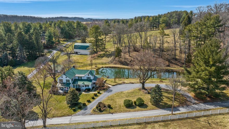 Total 2017 renovation updates this circa 1810 farmhouse to today's lifestyle while still retaining its old Maryland hunt country charm. Beautifully nestled on 8 acres, relax or dine on the screened porch overlooking the private pond with fenced pastures and bank barn beyond. Renovated and expanded to include 4 bedrooms and 2 new baths. Formal living room with stone fireplace and dining room, vaulted kitchen with white cabinets, large working island, granite counters and sunny breakfast area. The original kitchen is today's super laundry room/mudroom. The den or office with adjoining full bath and large walk-in closet can also function as a main level primary bedroom or guest suite.  3 large bedrooms and bath share the upper level. Vintage flooring and new hardwoods, Andersen and Pella windows, 2017 standing seam metal roof, all updated systems, zoned CAC and hot water radiator heat with radiant heat in kitchen and 1st floor bath. The pond is spring fed and provides water to the fenced paddock at the barn. Original stone foundations of the bank barn support the rebuilt upper block walls supporting the metal Dutch style roof. 3 large stalls, tack room and hay storage area are found in the lower level. A machine/equipment shed is adjacent the barn. Incredible jewel-box farm in the heart of Maryland hunt country! Offers presented as received.