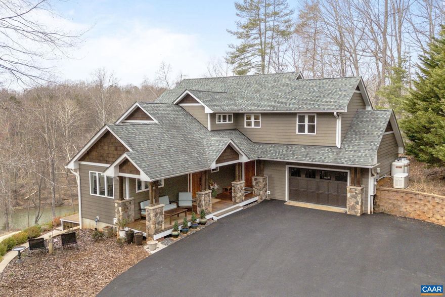 Escape to your private waterfront oasis in this stunning waterfront property. With breathtaking views of the river, 6.2 acres, a private beach and plenty of outdoor space, you'll feel like you're on vacation every day.  This gorgeous home features abundant windows to enjoy the views and for abundant natural light. Chef's island kitchen with beautiful cabinets and granite countertops.  Gaze outside from your comfortable vaulted great room with fireplace. Enjoy nature while working from your home office.  Wake up to morning coffee on the master suite balcony while enjoying the view.  2 additional large bedrooms and full bath on the upper level.  Walkout terrace level features spacious family room with fireplace and full bath.Beautiful hardwood floors throughout this lovely home. Lots of outdoor enjoyment to be found here with covered front porch, rear deck, plunge pool and large patio area with firepit.  Enjoy this private oasis while living only minutes from UVA, NGIC, schools, shopping and restaurants.,Granite Counter,Wood Cabinets,Fireplace in Family Room,Fireplace in Great Room