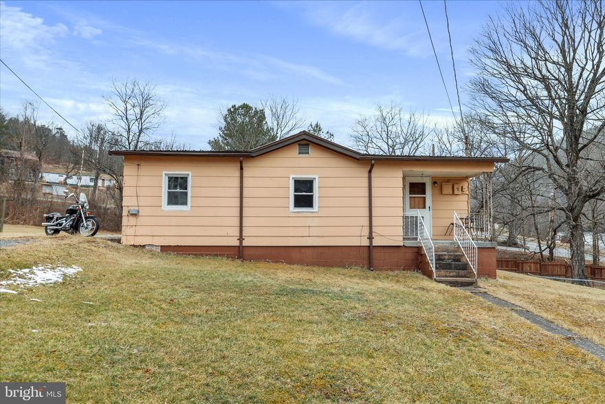 Simple. Solid. Affordable. A smart place to start. This 726± sq ft, 2-bedroom, 1-bath home sits on a level 0.59-acre lot and offers exactly what many buyers are looking for today: simplicity, efficiency, and opportunity. The home itself is straightforward and functional—easy to maintain, economical to own, and well-suited for someone ready to step out on their own and establish independence. The layout makes good use of the space, with two bedrooms, a full bath, and comfortable living areas that are practical and livable. What truly sets this property apart is the lot. The nearly 0.6-acre parcel is level, open, and highly usable, offering ample room for future expansion, a detached garage, workshop, or additional outbuildings—options that are increasingly difficult to find at this price point. The location is another strong asset. Situated close to local schools, shopping, and everyday conveniences, the property is well-positioned for buyers who want to stay connected to the community while still enjoying some breathing room. It’s an appealing setting whether you’re a long-time Mineral County resident or someone looking to relocate to West Virginia for value and practicality. Whether you’re a first-time buyer, downsizing, or an investor seeking a clean, manageable property with upside, this home represents an affordable entry point with room to grow. Honest housing. Real opportunity. A solid place to call your own