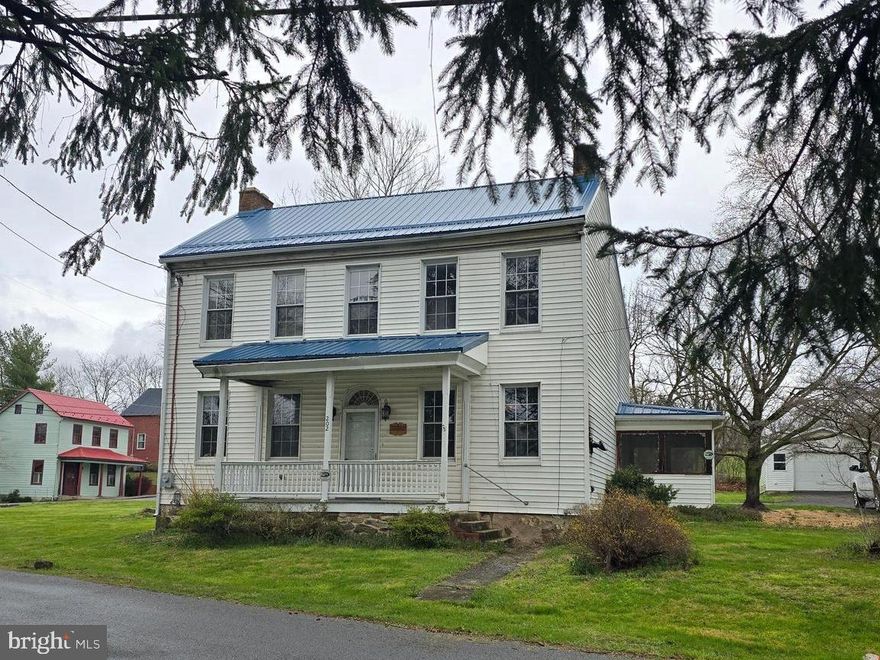 Large historical colonial priced to sell with newer metal roof. This home can easily be a 4 bedroom 2 bath home. Enough space to allow your vision to cut loose as you bring this home back to its full stately potential. Two large rooms on the main level with built in cabinets and shelving. The kitchen has space for dining in the adjacent room with plenty of pantry space. Screened in side porch from the circle driveway.  Two oversized bedrooms on the upper level with a full bath and another bedroom off to the back. This is the same location for the laundry room on the upper level. The garage in the back has electric and pedestrian door for easy access to the garden area. This home is being sold "as-is" at a reasonable price to allow you to make the changes and upgrades that fit your specific needs and desires. The large lot may afford an additional building lot for the the investor or investor/builder. Make your offer today.