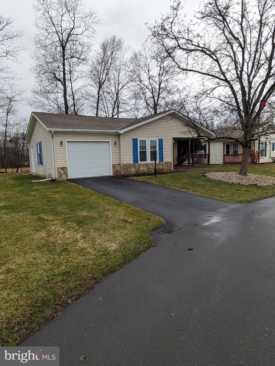 Privacy in Buckingham Springs! This inviting Gwynedd Model features a cozy front-to-back layout with 2 bedrooms and 2 bathrooms, as well as an attached Garage. Enjoy the warmth of a fireplace when the winter is at hand, but during the warmer months you can either enjoy the sunroom or set up a delightful side yard oasis - both give you fantastic views of the trees and the open pasture beyond. This is set at the edge of the community, with no neighbors behind and a wide open space next door. Updated windows and HW Heater. The community offers fantastic amenities, including a clubhouse and pool, fostering a vibrant social atmosphere managed by a professional team. Easy access to Doylestown, New Hope, and Newtown, as well as I-95. This is a great opportunity to get into a Gwynedd model and share in a low-maintenance, high-fun lifestyle!