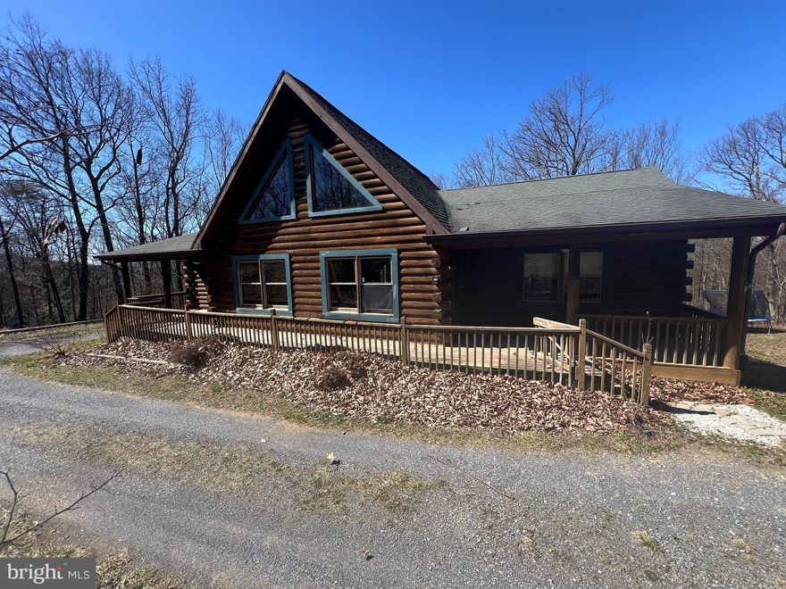 Welcome to 363 Laverne Dr  a stunning  3200 sq ft log home built in 2006 to find a true 4 bedroom 3 FULL BATH home with a full  finished  basement nestled on 3 wooded acres of tranquility !Home offers a completely finished basement with 2 bedrooms, office , storage space ,and a full bath . Moving upstairs there are 2 more bedrooms including a spacious Master Suite, two more full baths , a nice kitchen ,large living room with lots of natural light and a large loft area that could even be turned into a 5th bedroom or another room with additional living space ! Outside features include two large decks,   all situated on 3 wooded acres . Did I mention the great location ? This beautiful home is only 1/4 mile off US RT 50 and 30 minutes West of Winchester VA ! Enjoy the serene surroundings on your expansive decking ! This log home offers a truly idyllic retreat for those seeking peace and privacy. There is no way this home could be duplicated at current list price so see this one first and you'll be glad you did ***!Highest and best offers due by 4/8/24 at noon ***